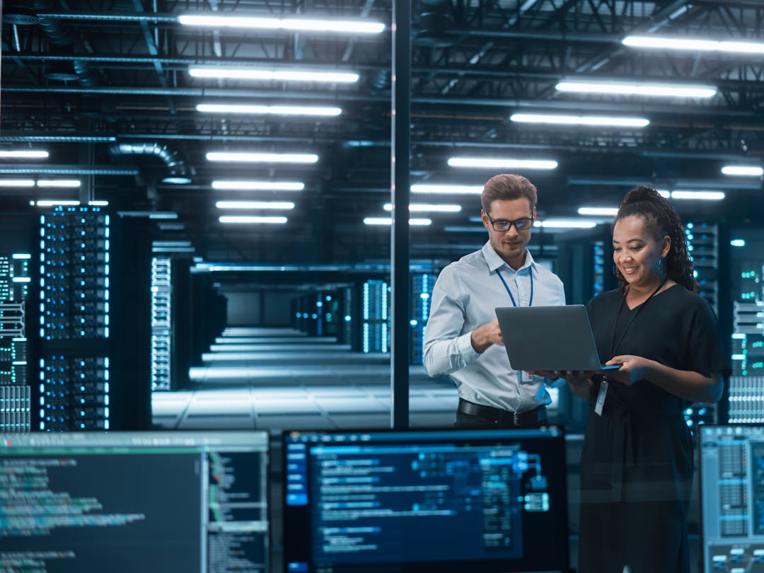 Cyber security employees in discussion in a server data center