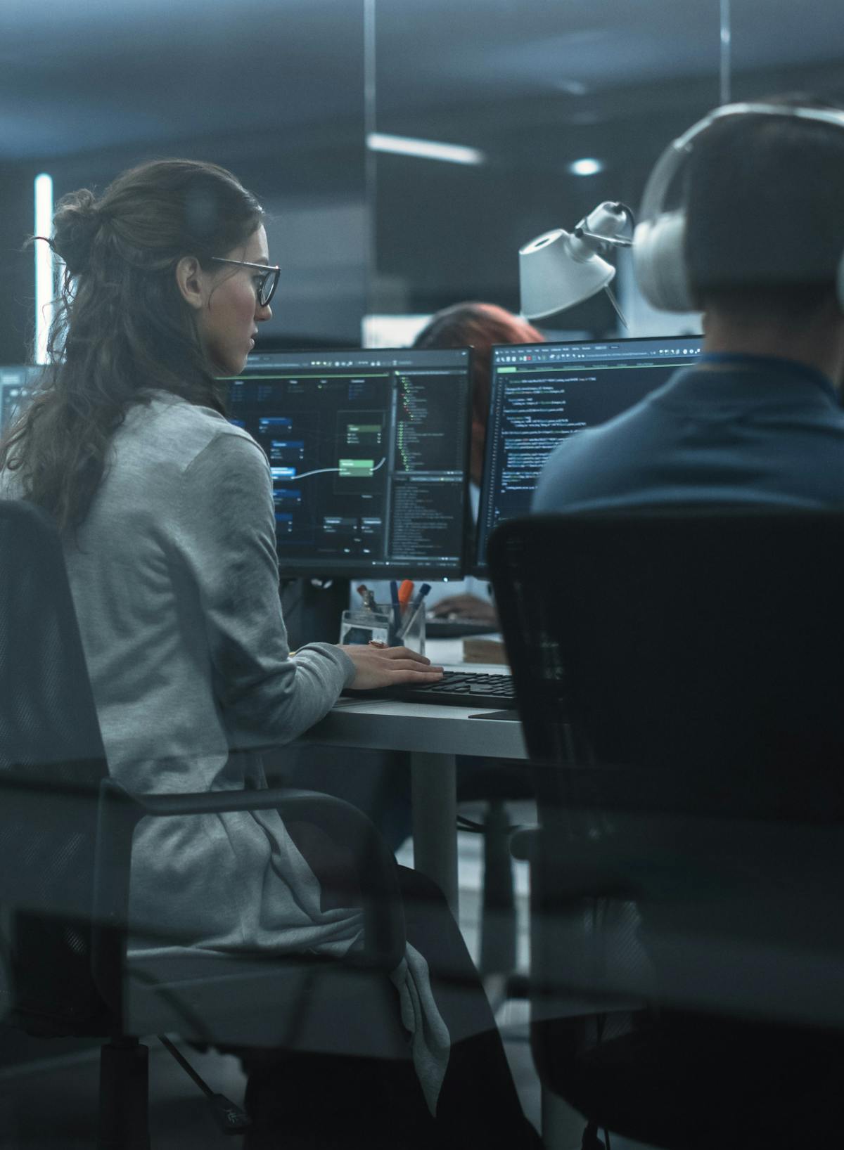 Team of cyber security professionals working at their computers