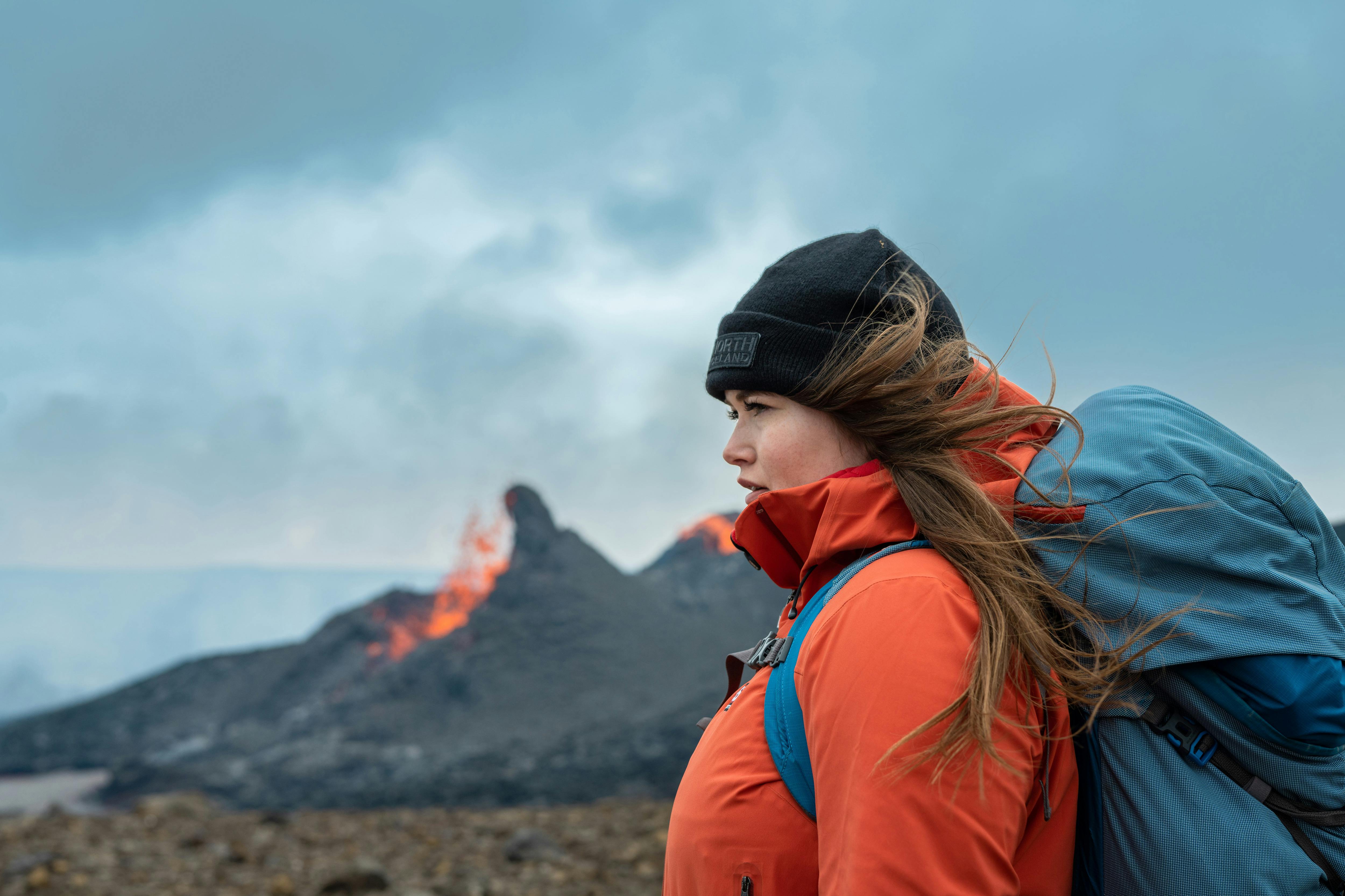 Helga Kristín in front of the erupting volcano