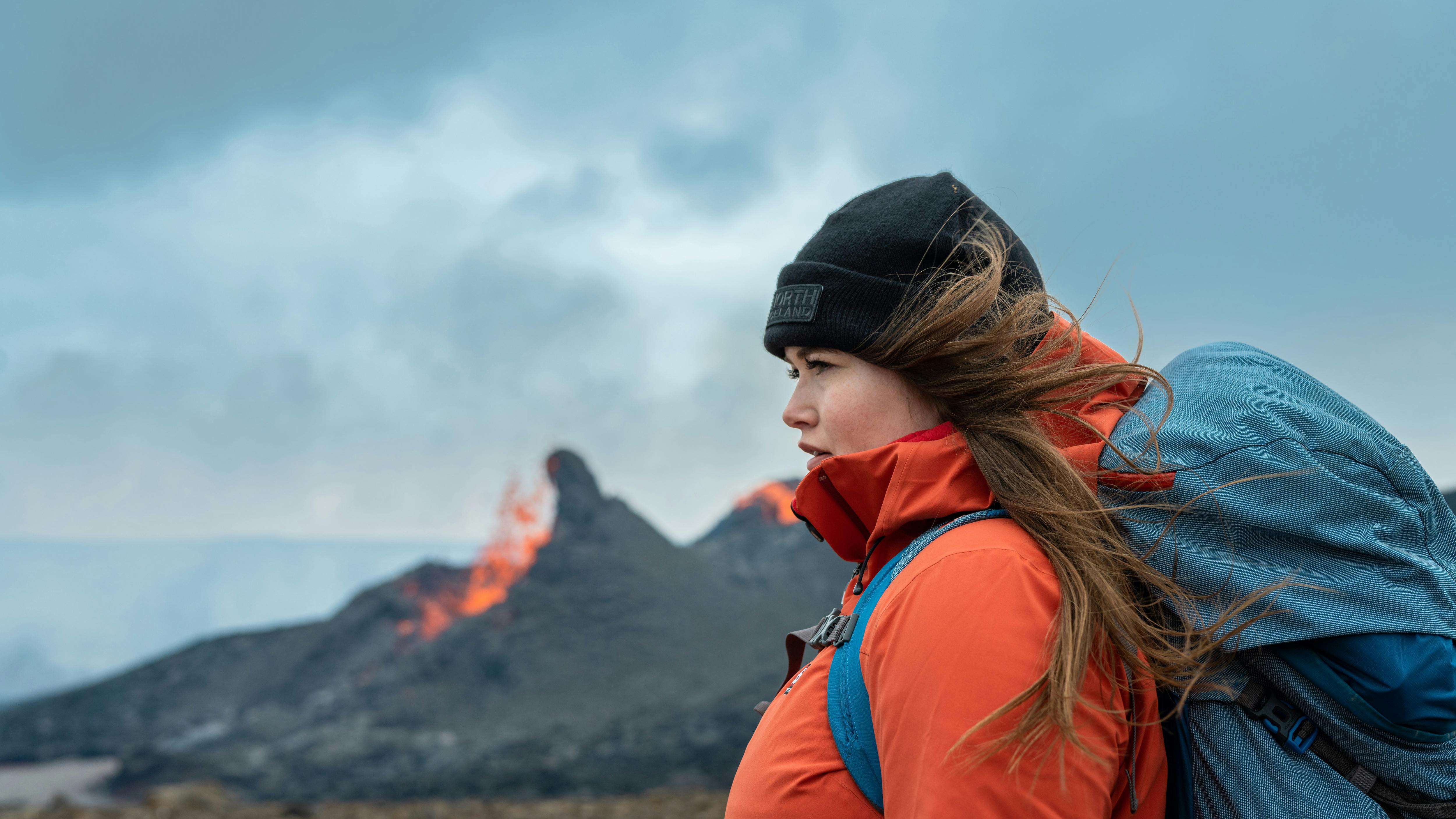 Helga Kristín in front of the erupting volcano