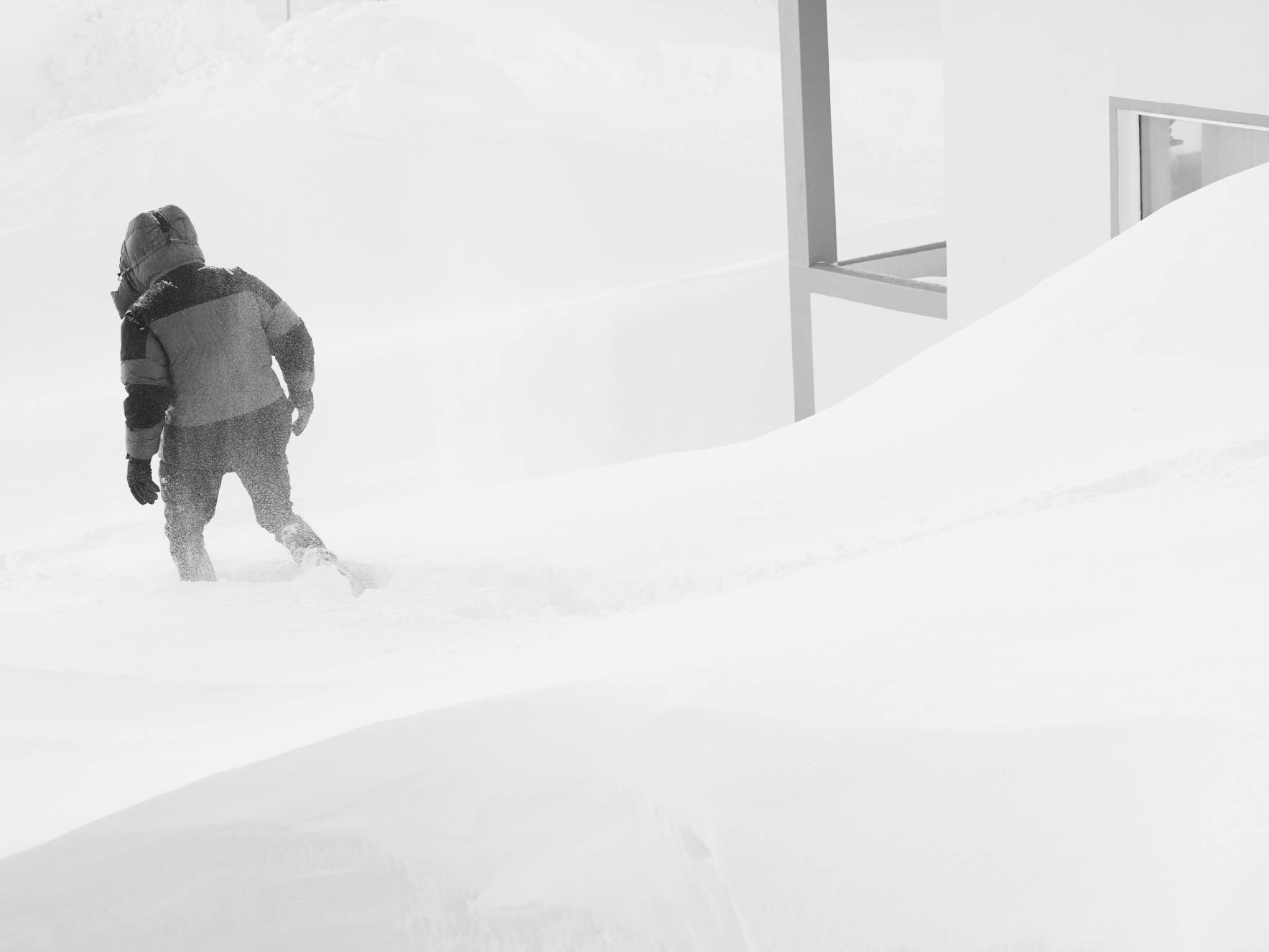 Man wearing tindur down in a snow drift