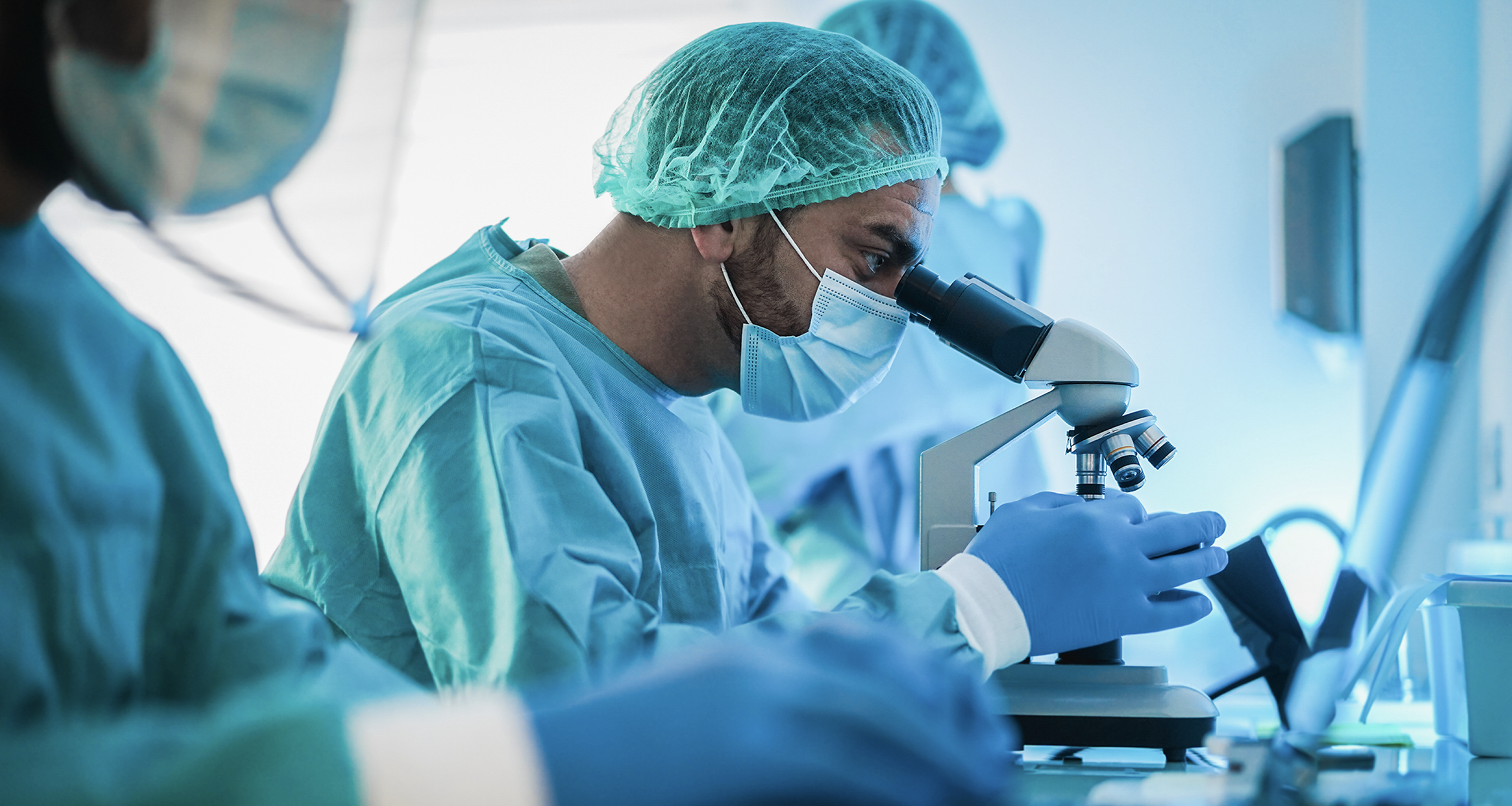 Photo of a researcher observing a sample under a microscope.