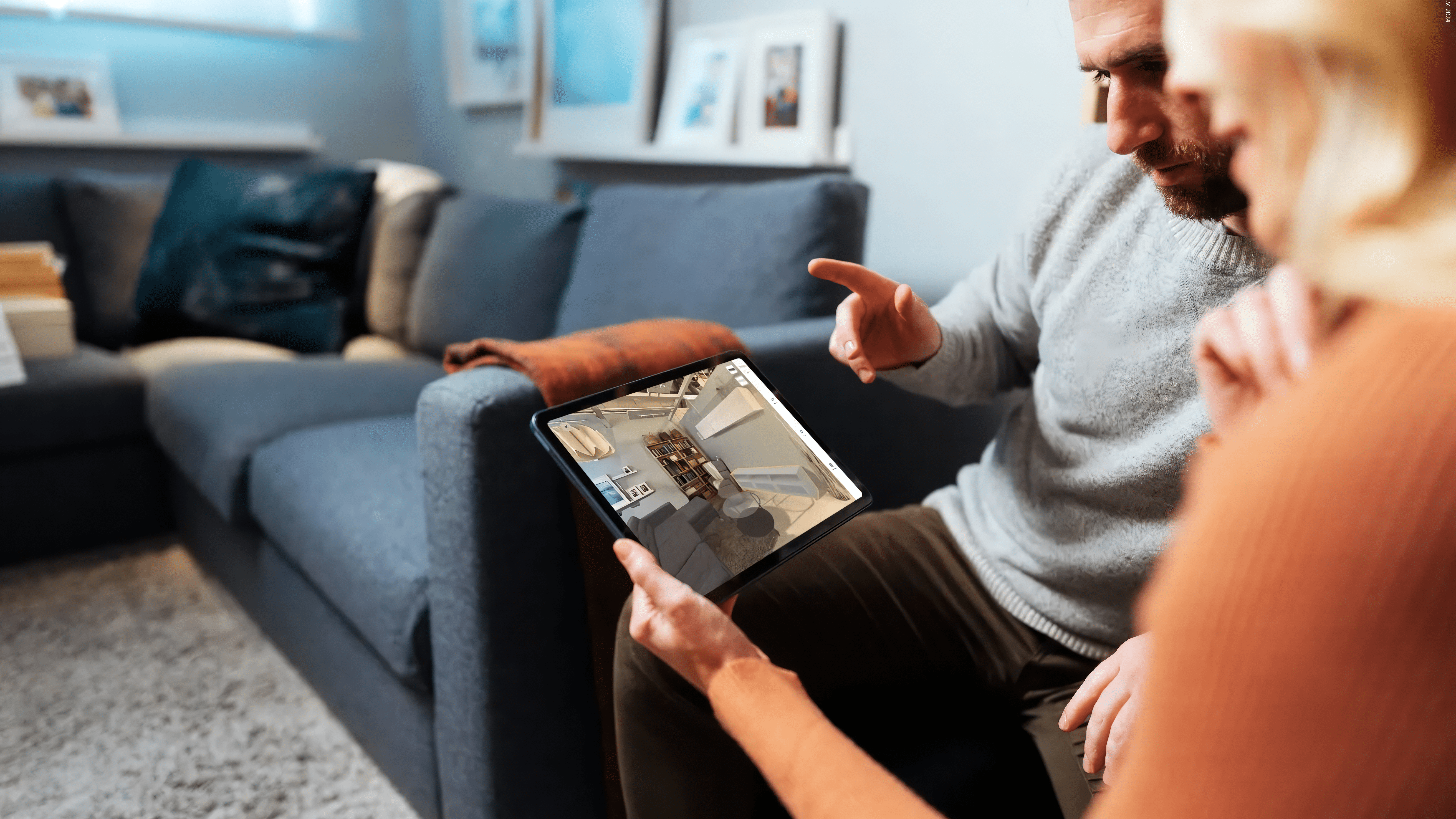 Two people are using the IKEA Kreativ interior design app.