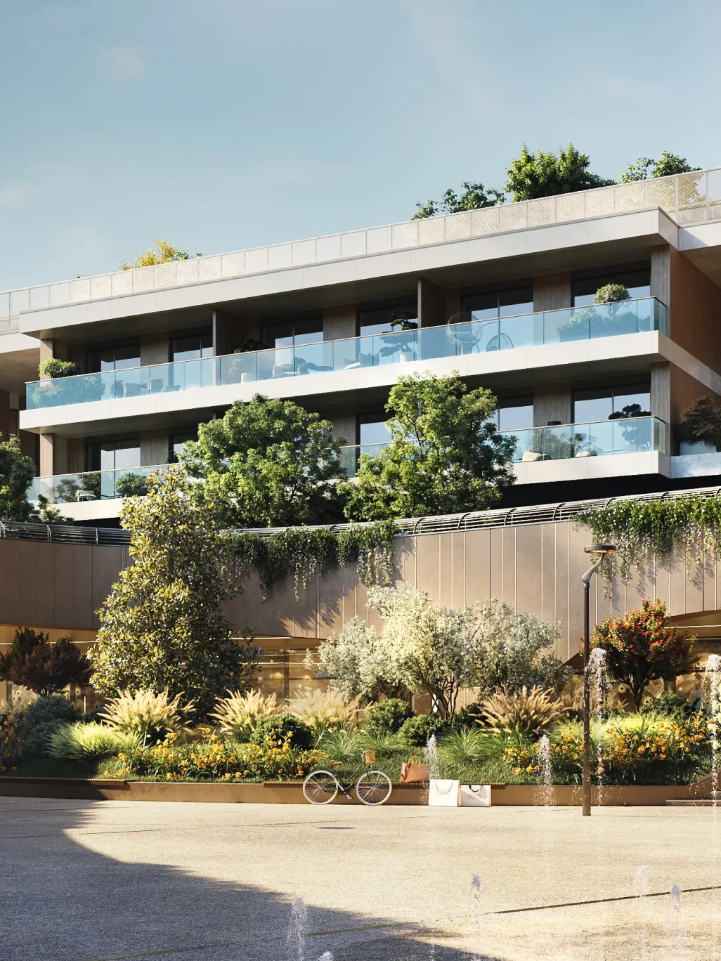 District residential building with large balconies and plants, surrounded by a green area with gardens, fountains and a parked bicycle