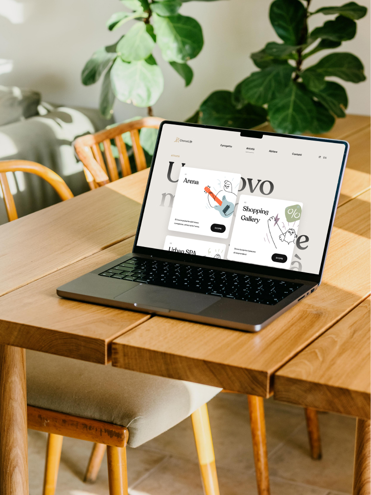 Laptop on a wooden table displaying the ChorusLife website, with options for the Arena, Shopping Gallery, and Urban SPA