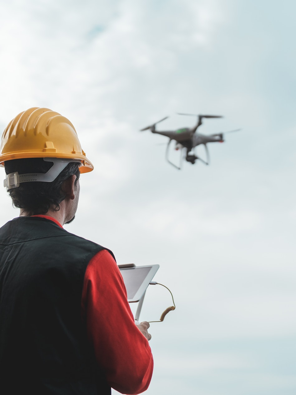 Worker uses a drone to check the infrastructure 