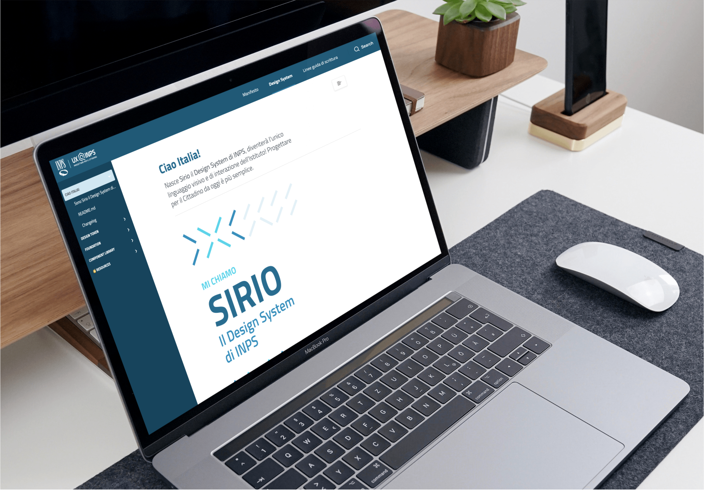 Sketchin Services, Digital product and service design - Laptop displaying INPS Sirio Design System interface, placed on a desk with mouse and accessories.