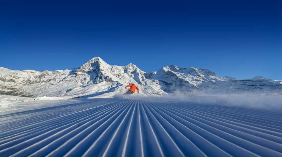 Skier enjoys freshly groomed ski slope in the Jungfrau Ski Region