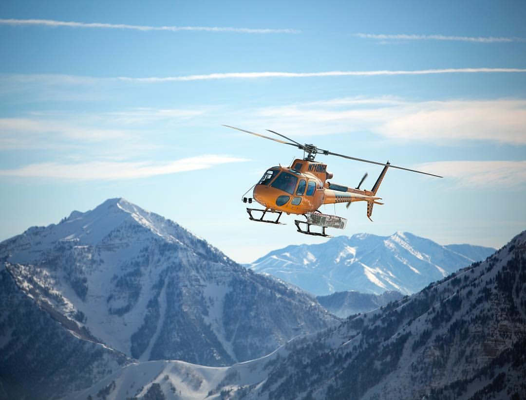 A helicopter operated by Utah Powder Birds escorting skiers to the summit at Utah.