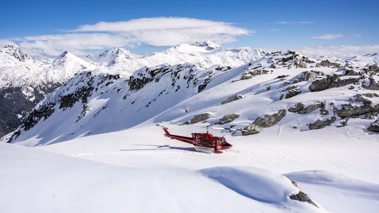 A helicopter resting on a slope in Whistler Blackcomb in British Columbia, Canada.