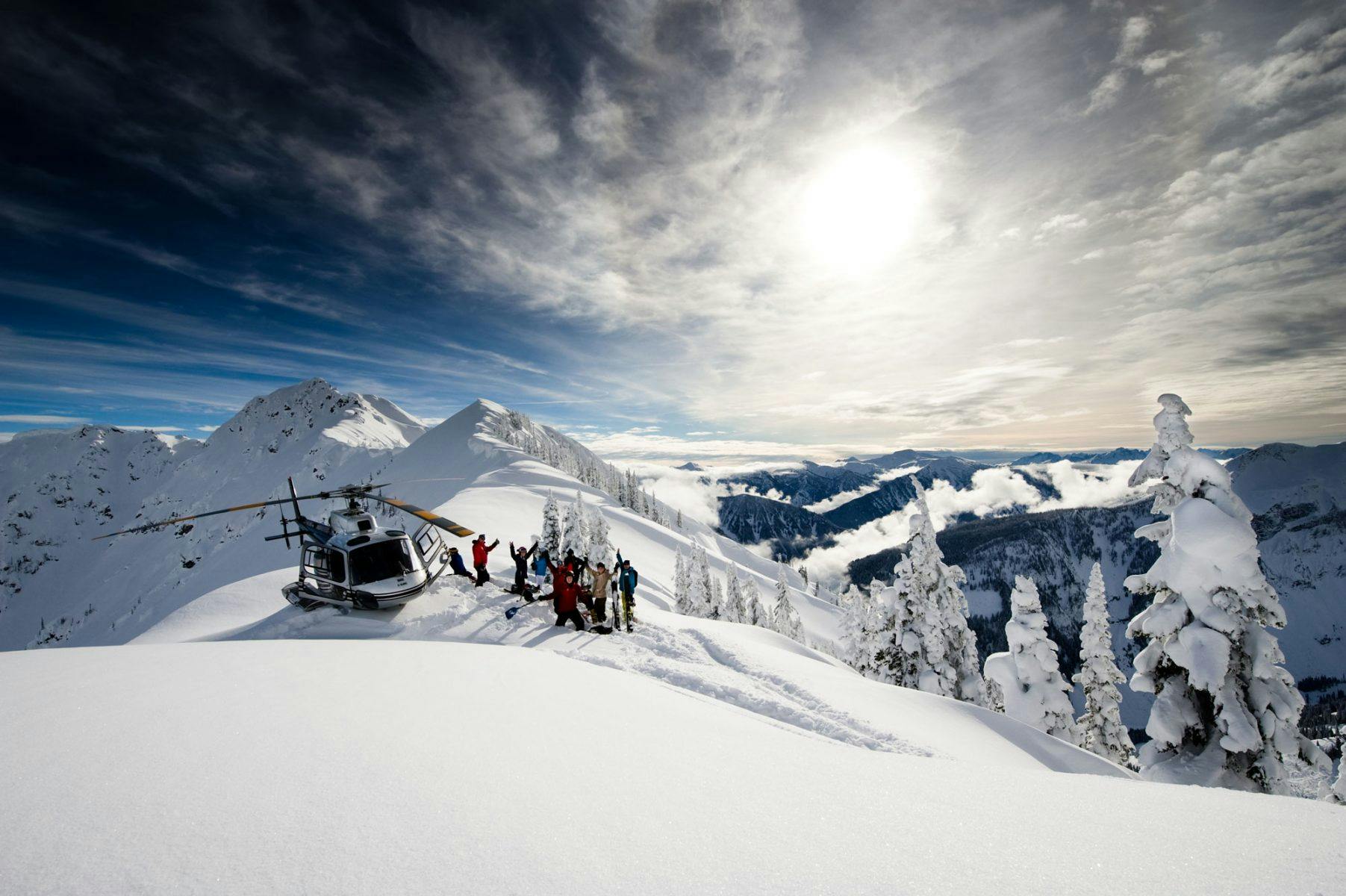 Skiers at the summit getting ready for a heli-skiing adventure in Revelstoke in British Columbia, Canada.
