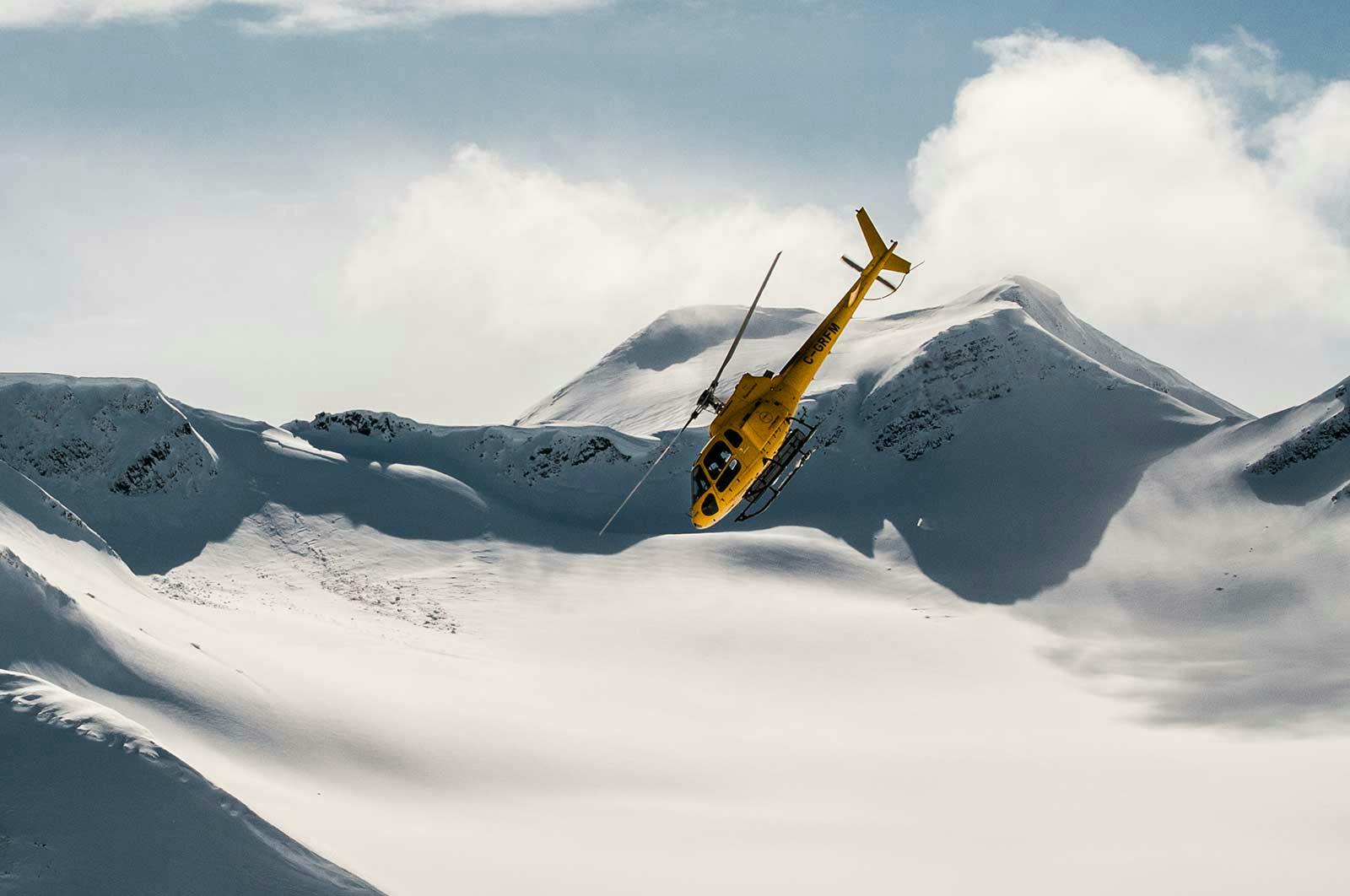 Last Frontier Heli-skiing helicopter in descent in Revelstoke in British Columbia, Canada.