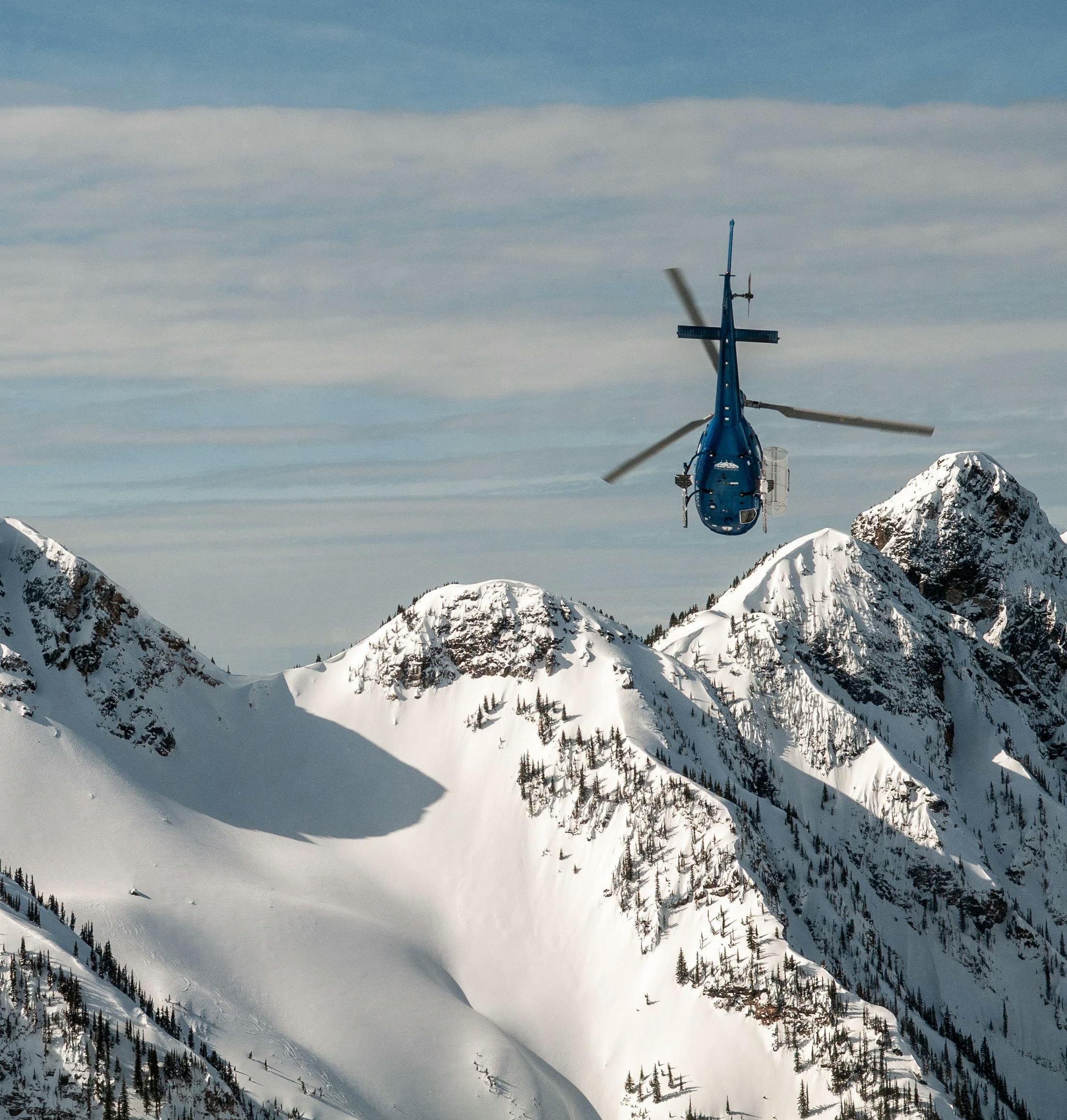 A helicopter taking skiers to the summit near Eleven Lodge in Revelstoke in British Columbia, Canada.