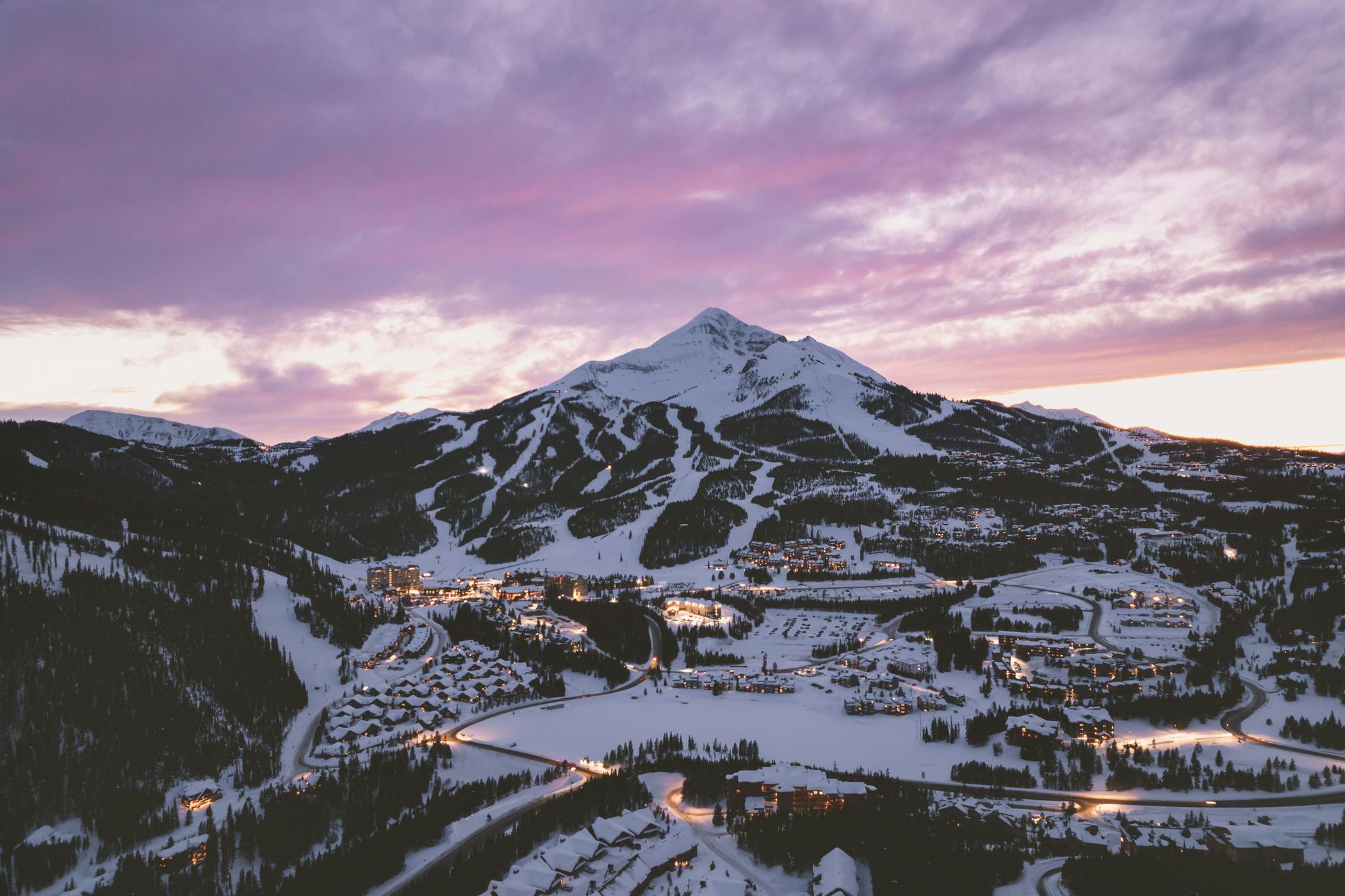 A pink sky sunset over the slopes at Big Sky Resort