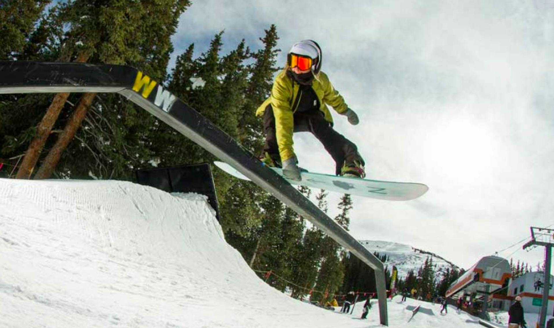 snowboarder on a rail at Woodward Park at Copper Mountain