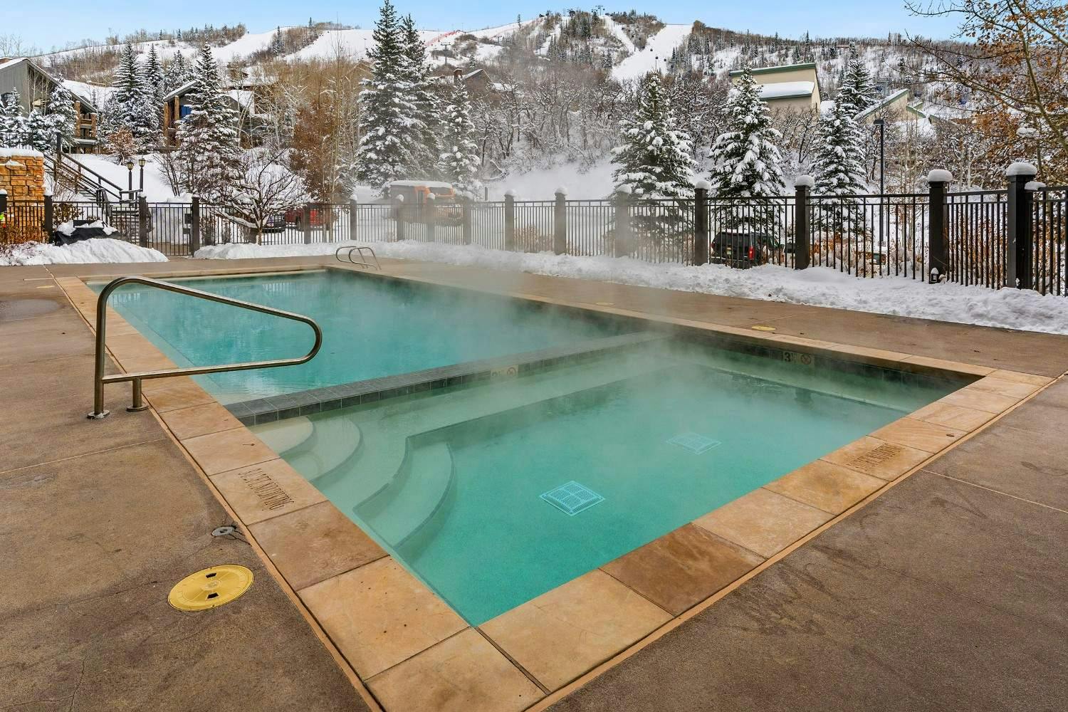 steam rises off the hot tubs at bear claw condominiums in steamboat springs colorado