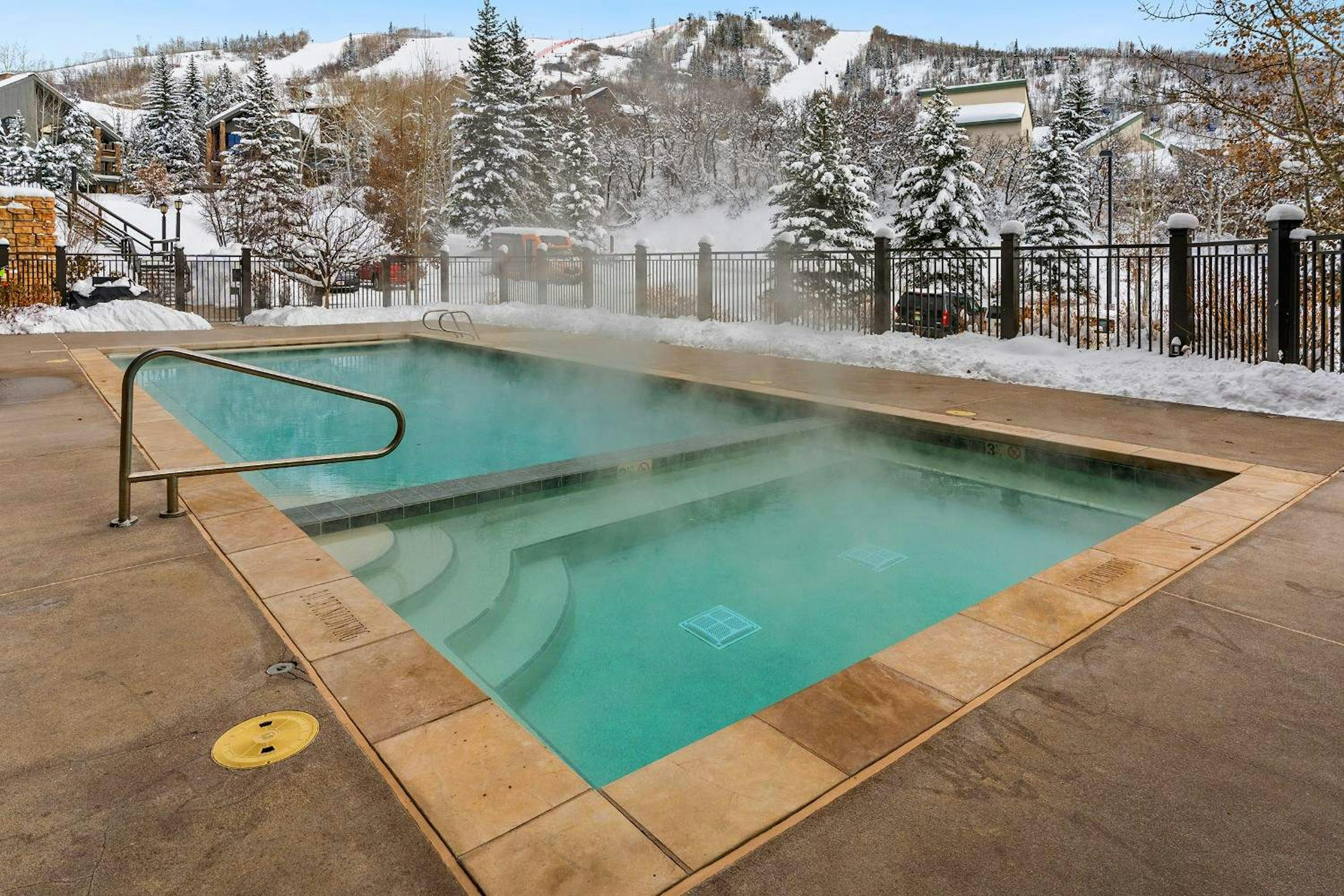 steam rises off the hot tubs at bear claw condominiums in steamboat springs colorado