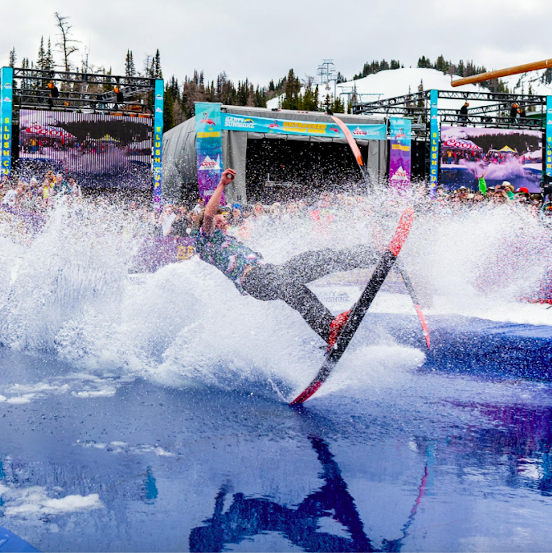 skier flailing as they skim a water pond at Banff Sunshine Slush Cup 