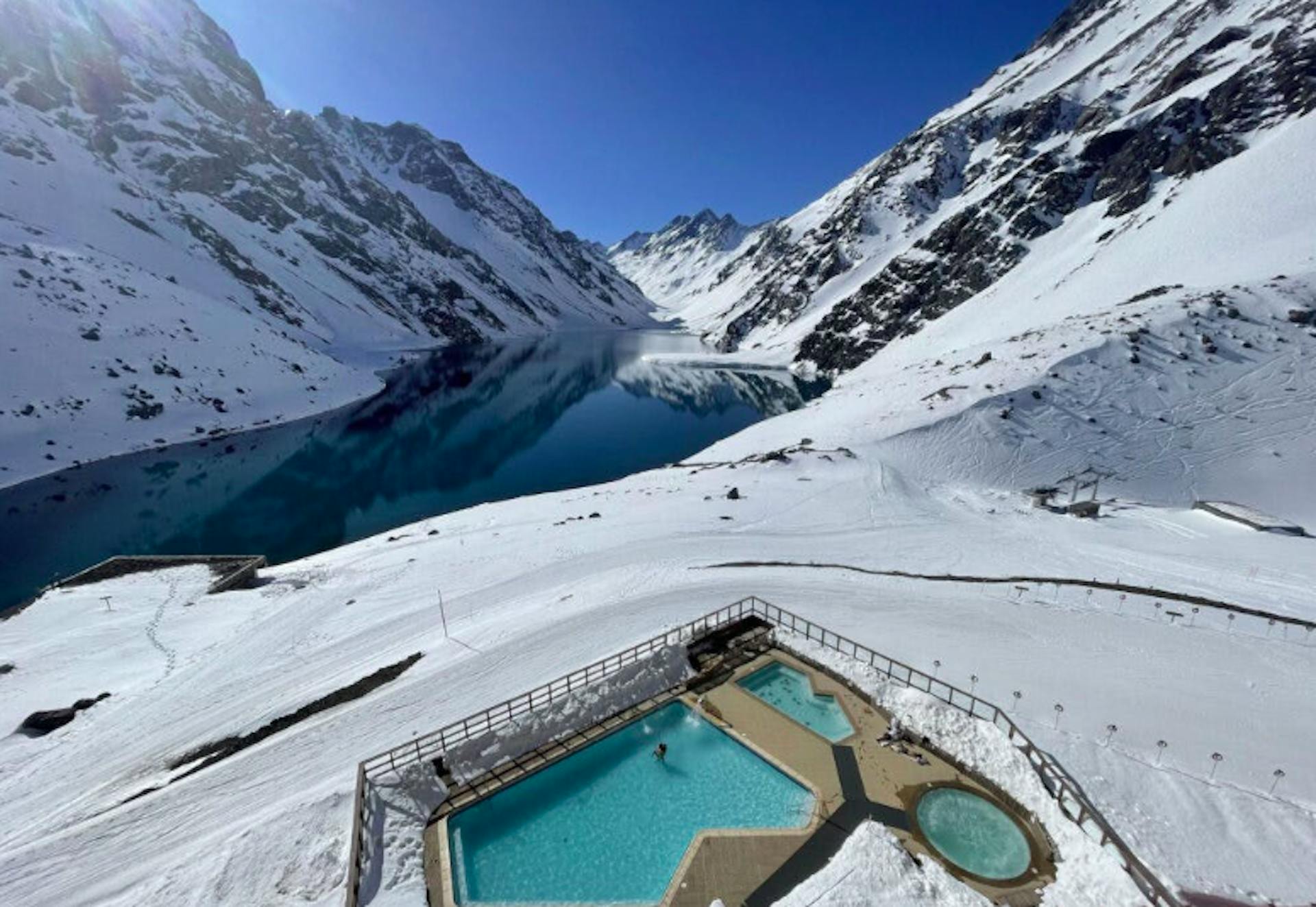 Portillo Chile ski resort pool with alpine lake and snowy mountain backdrop