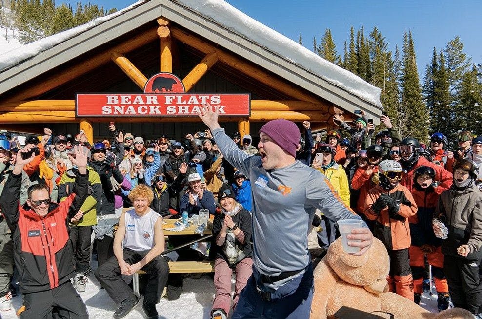 Large group of people smiling and having fun at an afternoon party outside a lodge at Jackson Hole ski resort