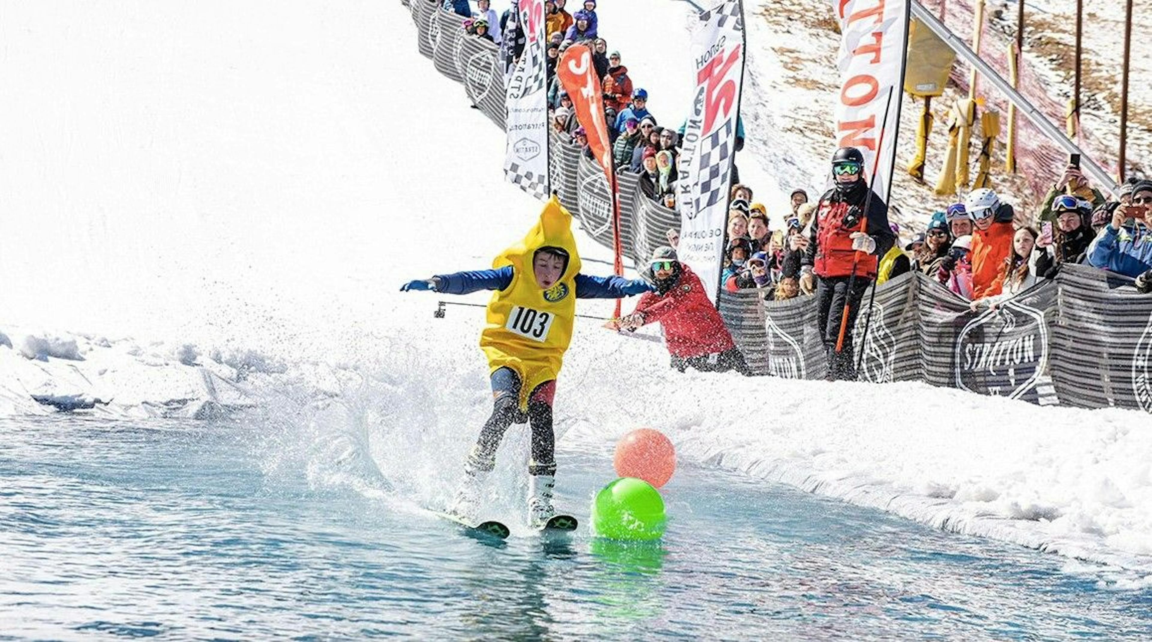 Kid in a banana costume doing pond skim event at Stratton Mountain