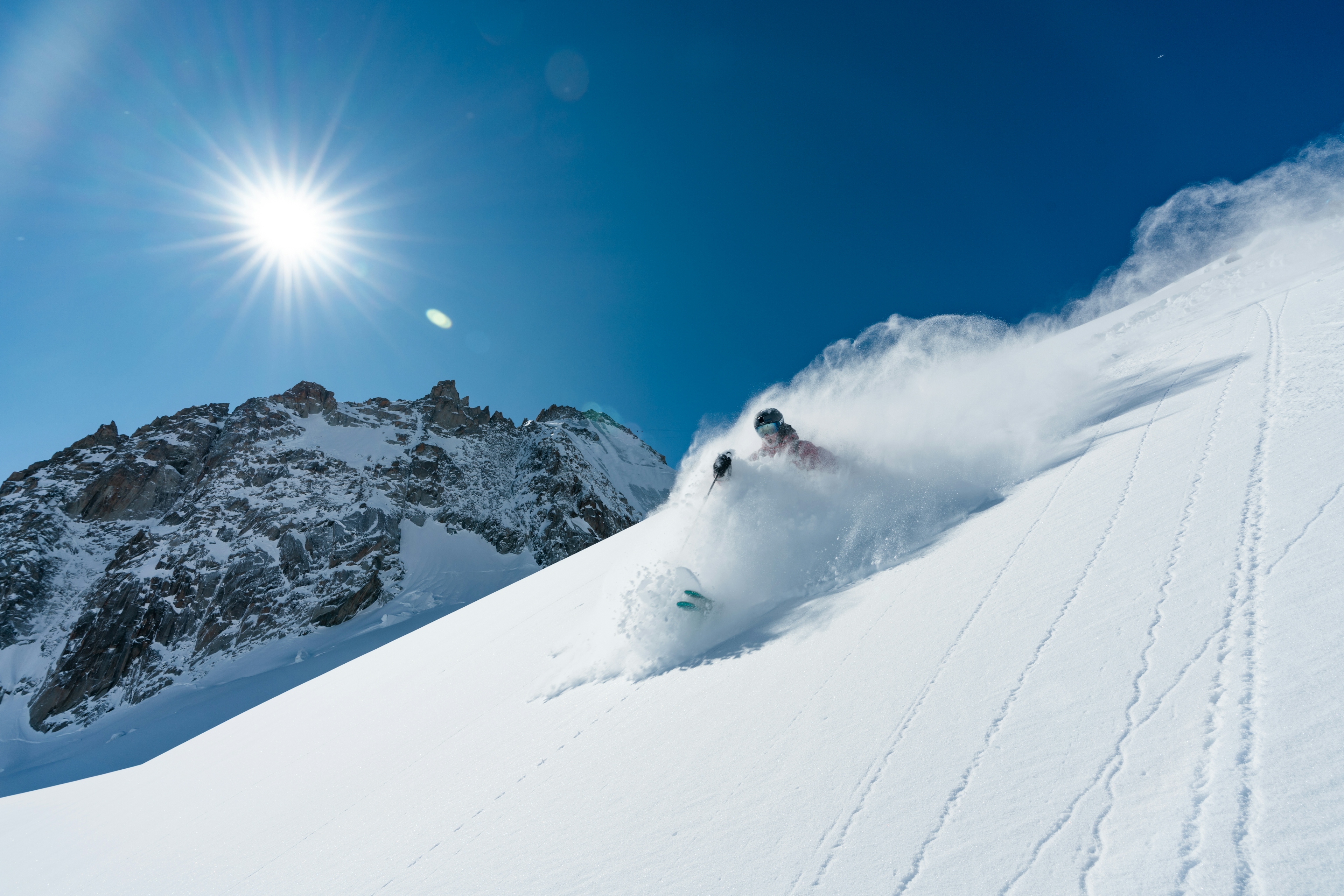 Skier skiing in deep powder snow.