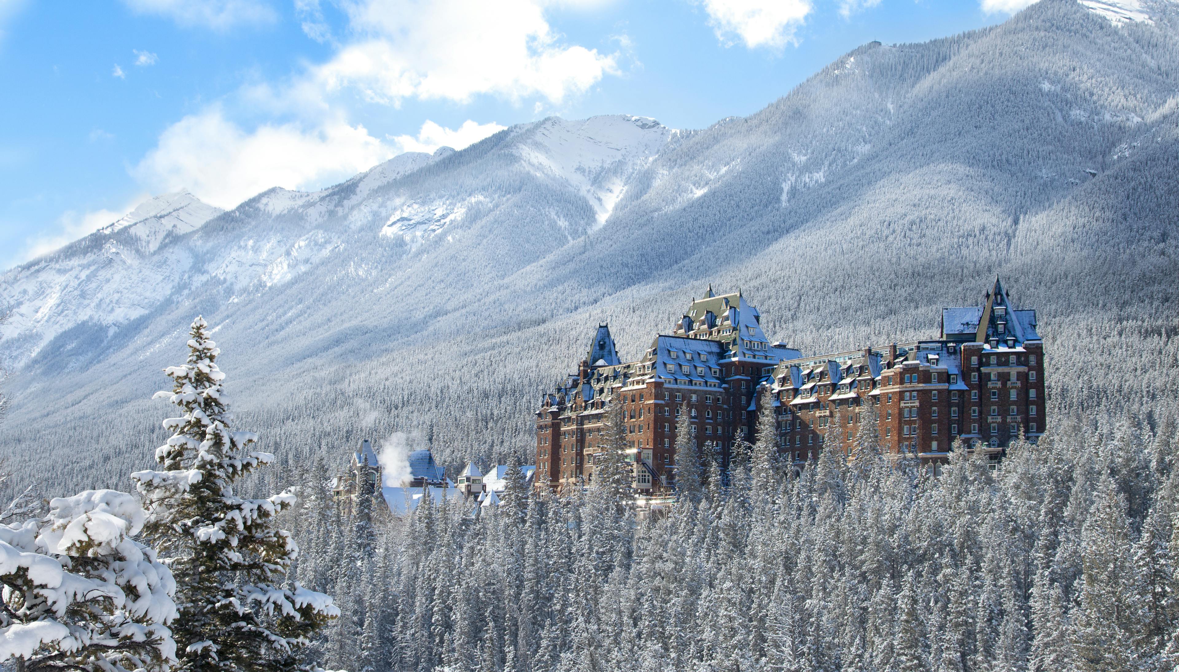 The Fairmont Banff Springs against a snowy backdrop.