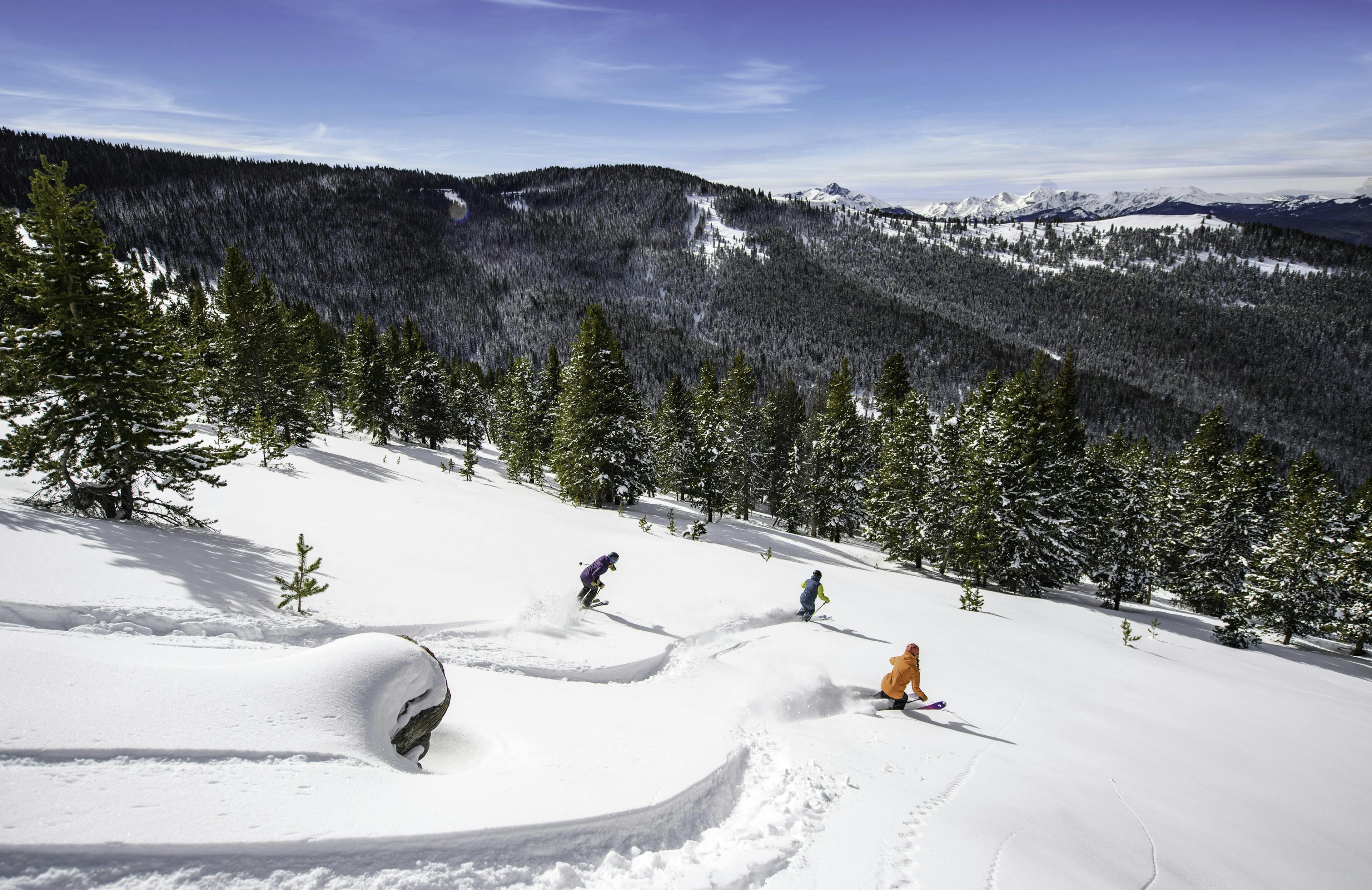 Friends skiing powder at Vail