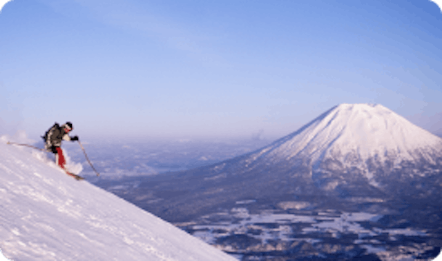 Skier in Japan with volcano in the back