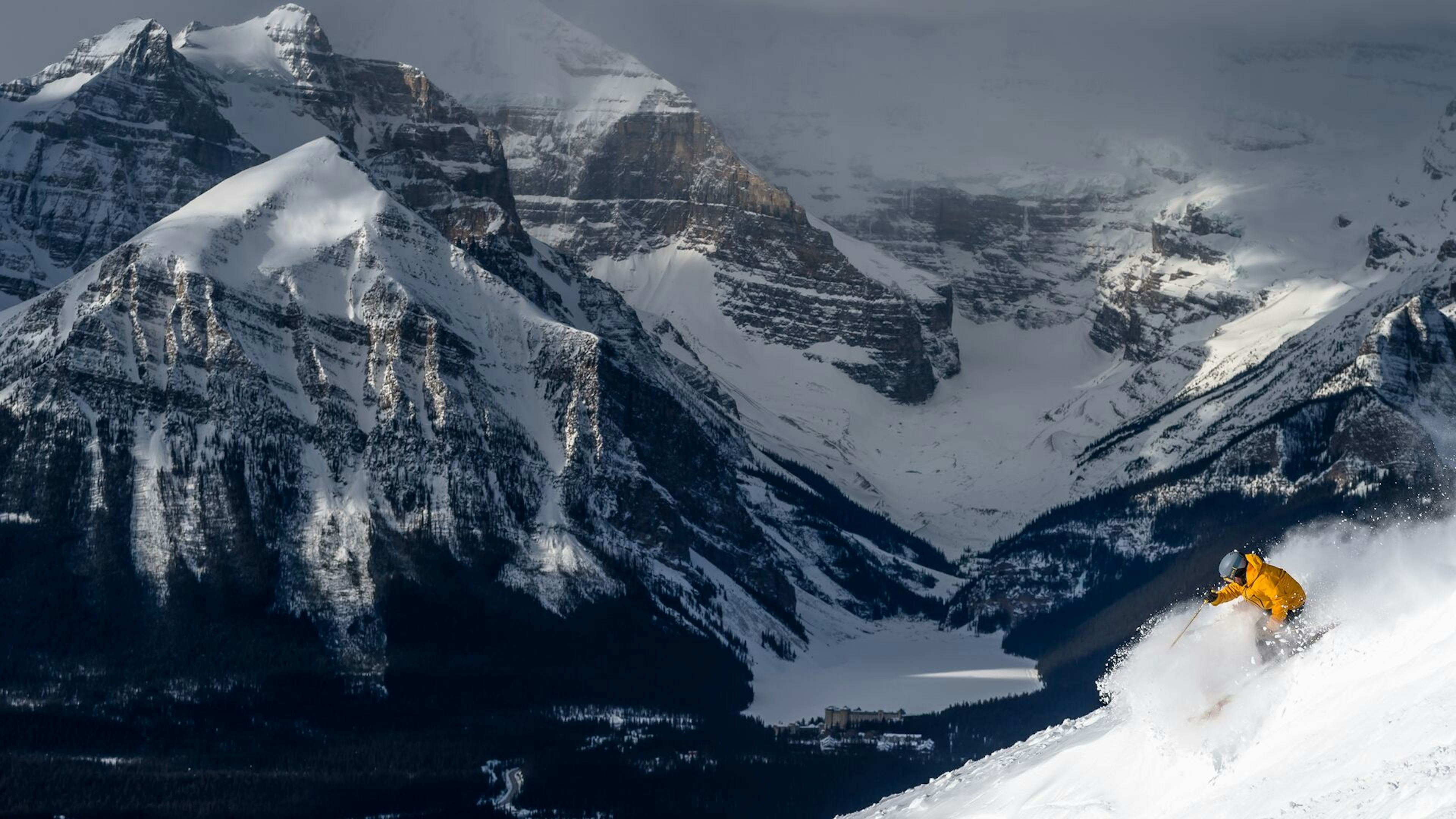  A man skiing down a snowy mountain in Canada