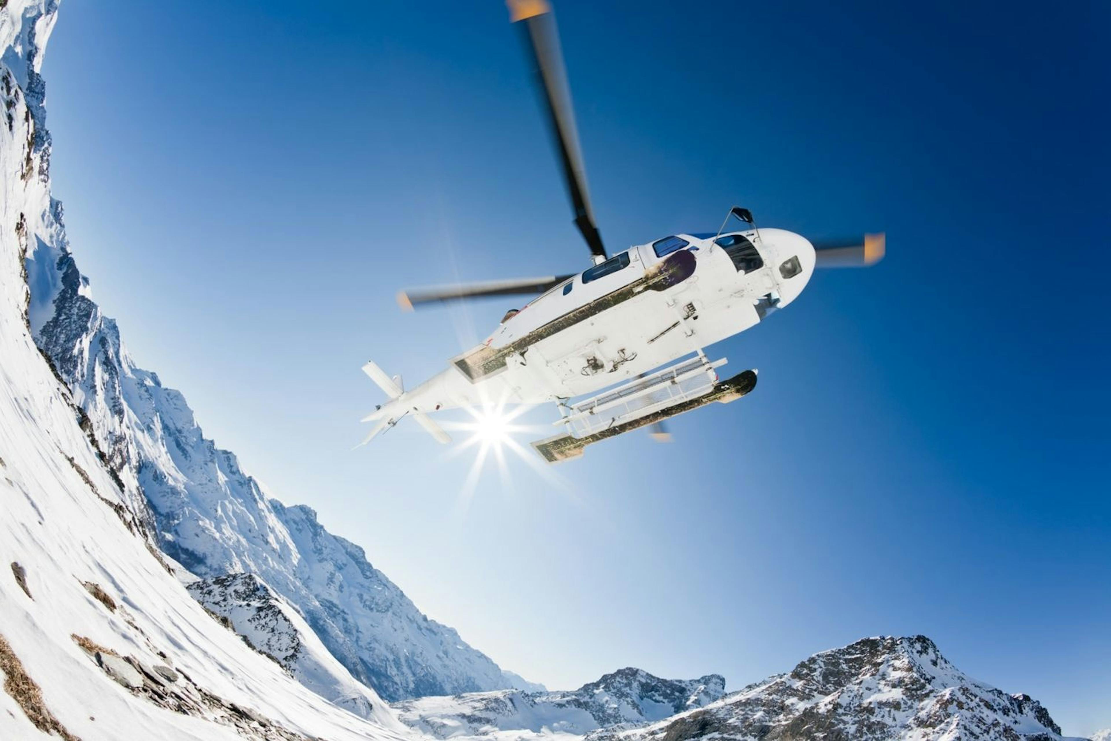 A helicopter navigates the skies above Whistler's mountain range