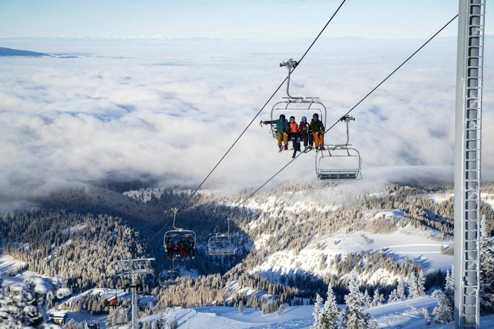 Ski chairlift ascending a snow-covered mountain
