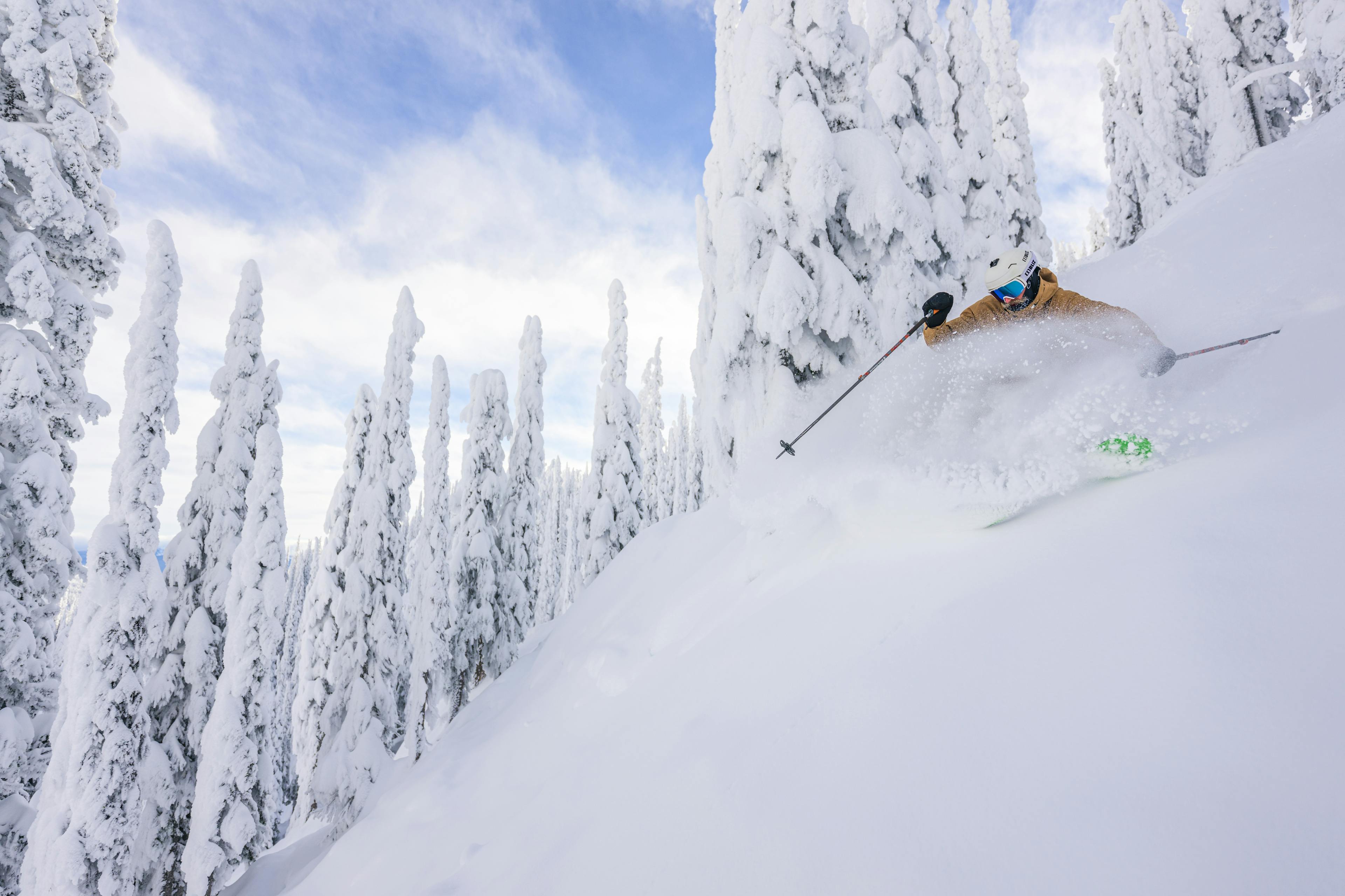 Skier skiing powder in Big White Ski Resort.