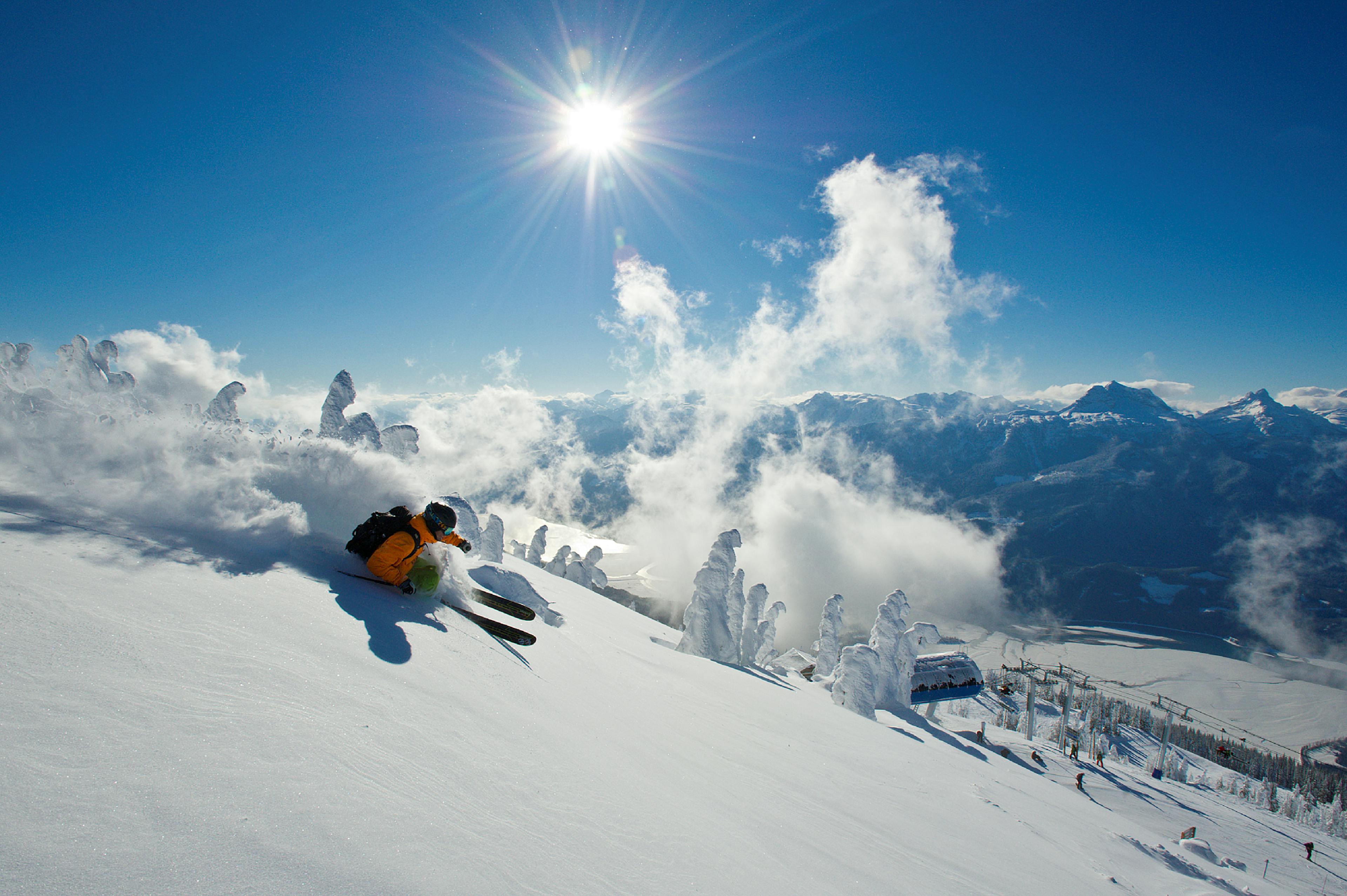 Skier skiing powder in Revelstoke.