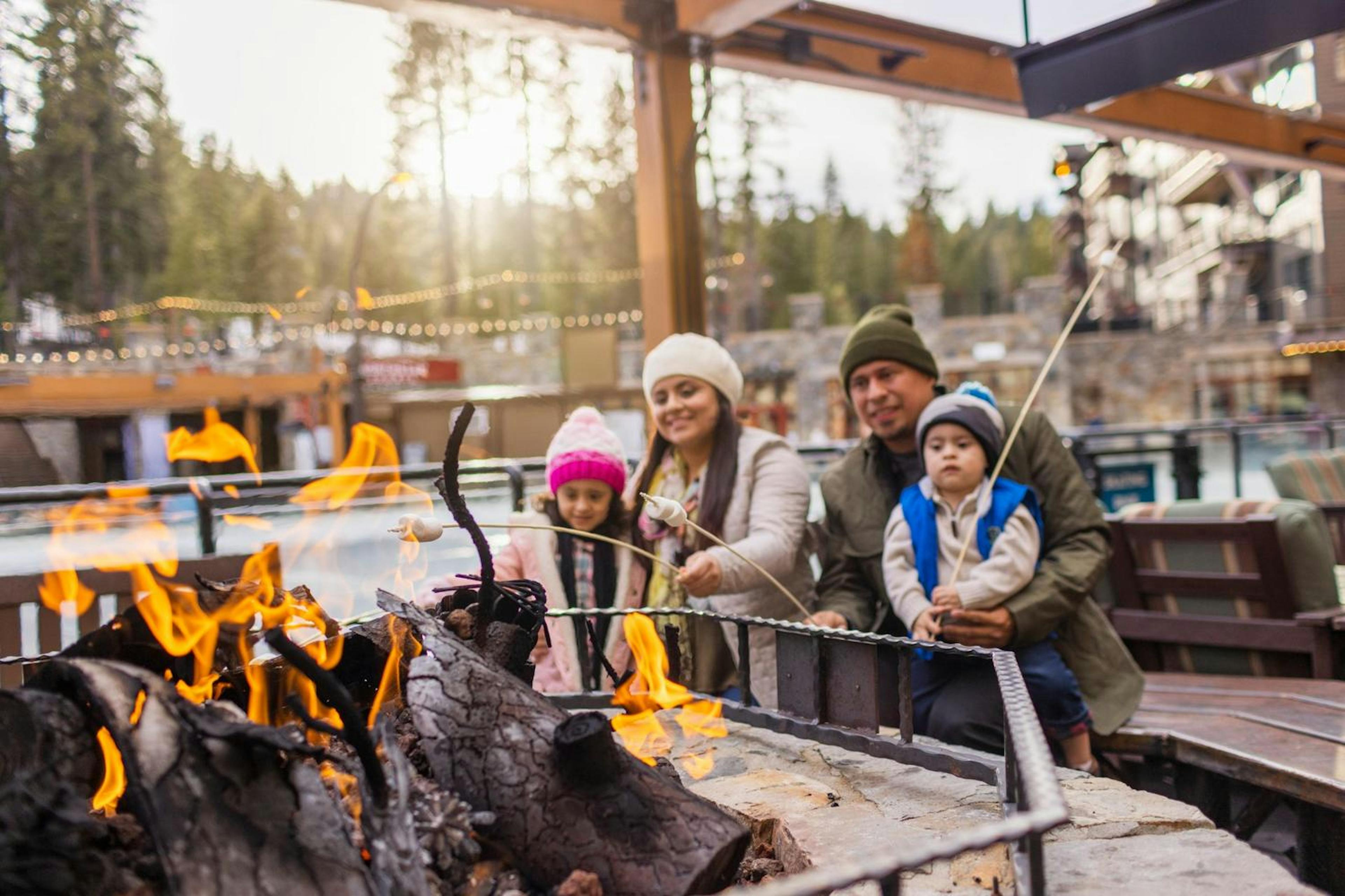 Family roasting marshmallows in the village at Northstar Resort