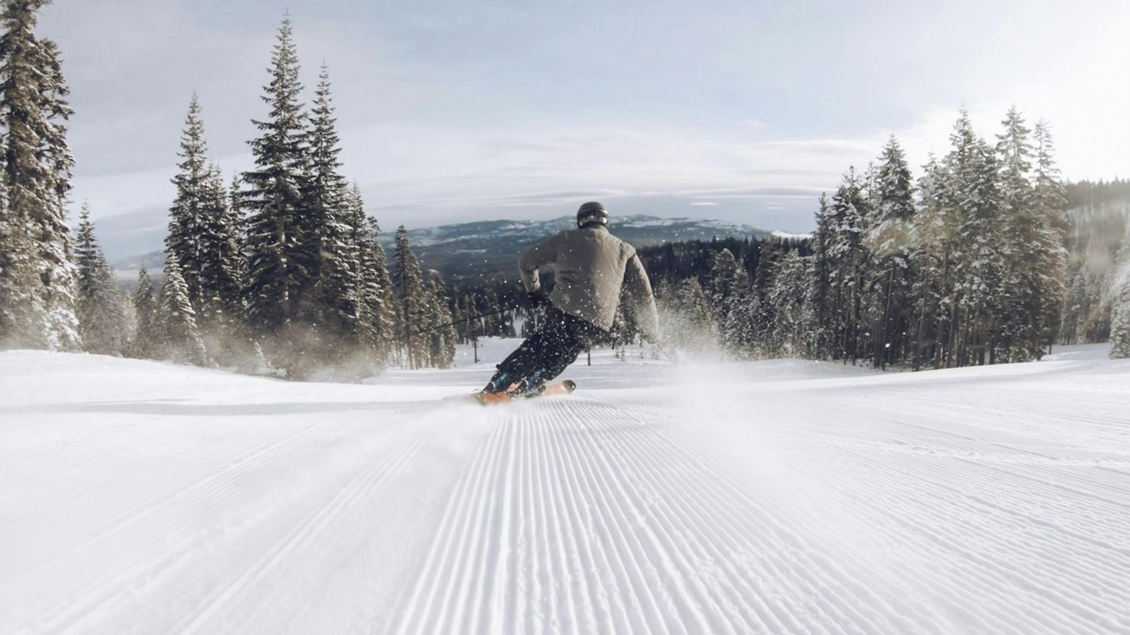 Skier skiing corduroy at Northstar Resort