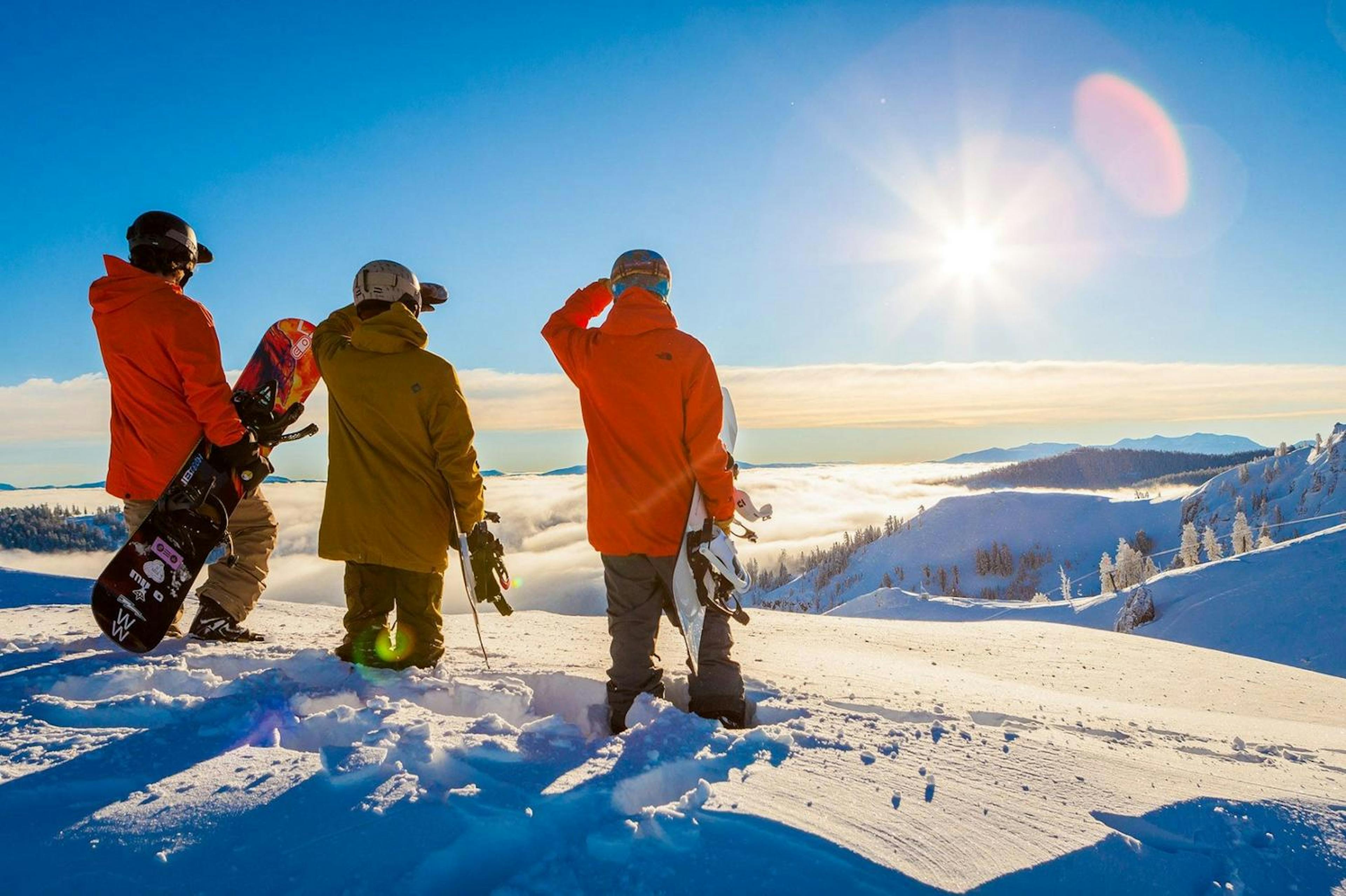 Snowboarders in knee deep powder at Palisades Tahoe