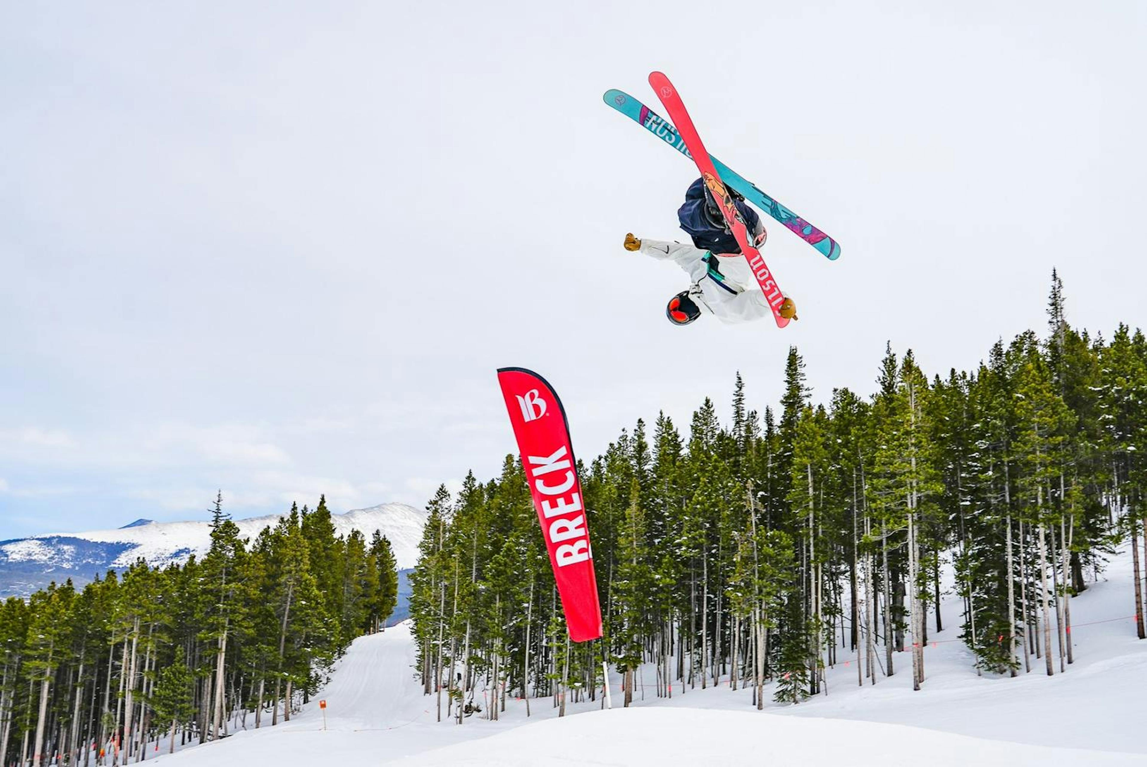 A skier going off a jump at Breckenridge ski resort.