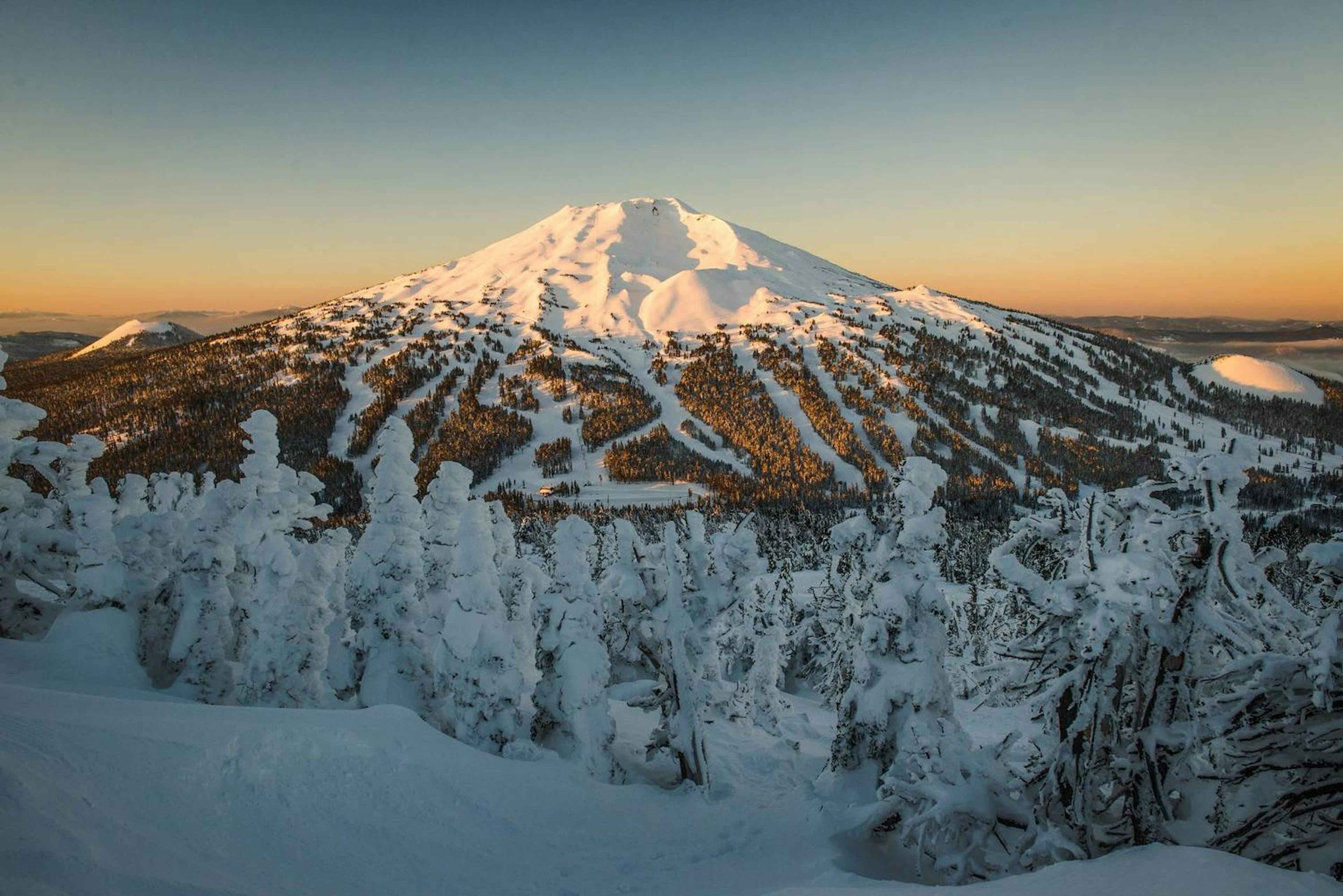 Wide shot of Mount Bachelor with ski runs visible at sunrise.