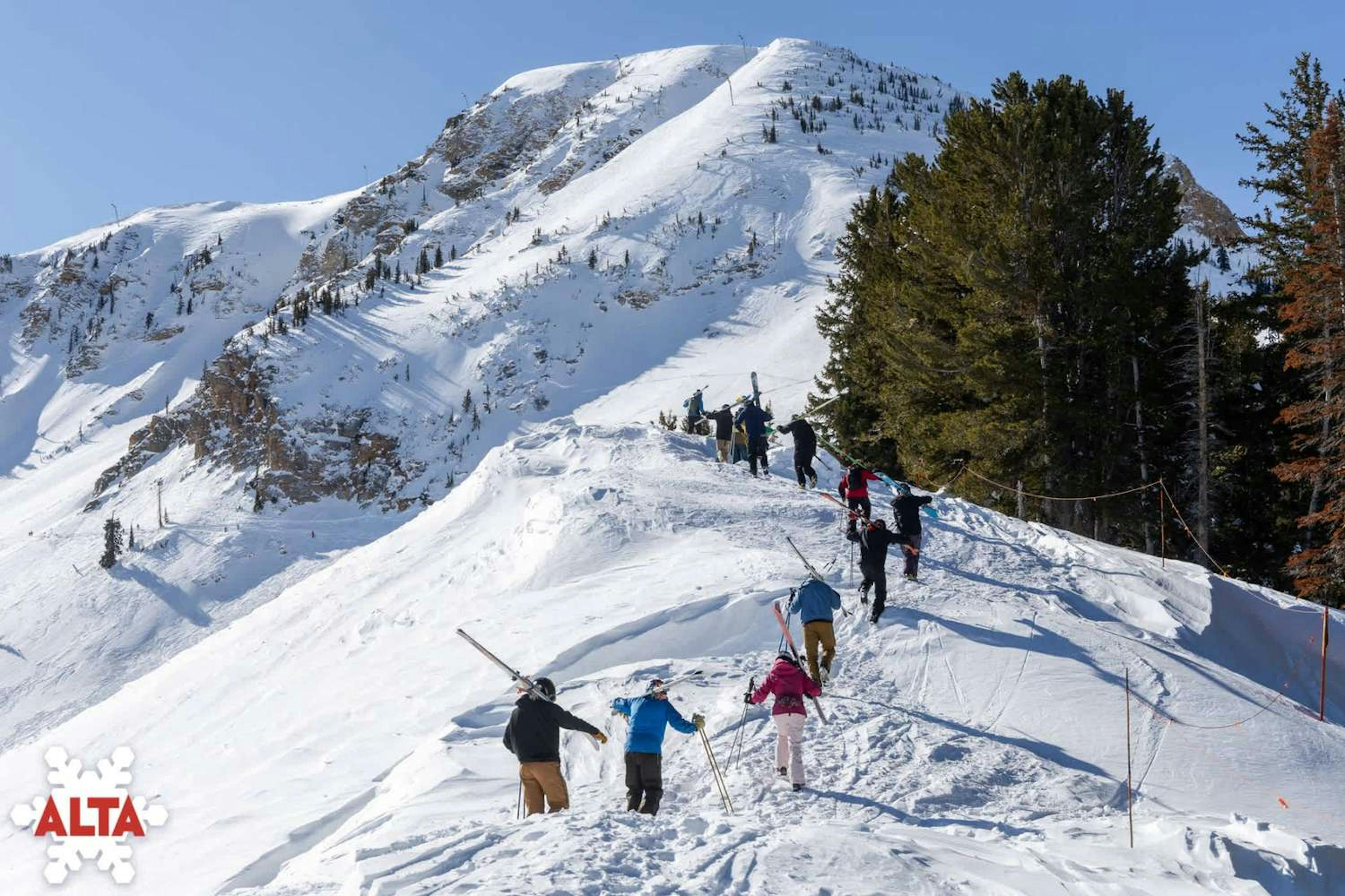 Skiers boot packing up a ridge at Alta.