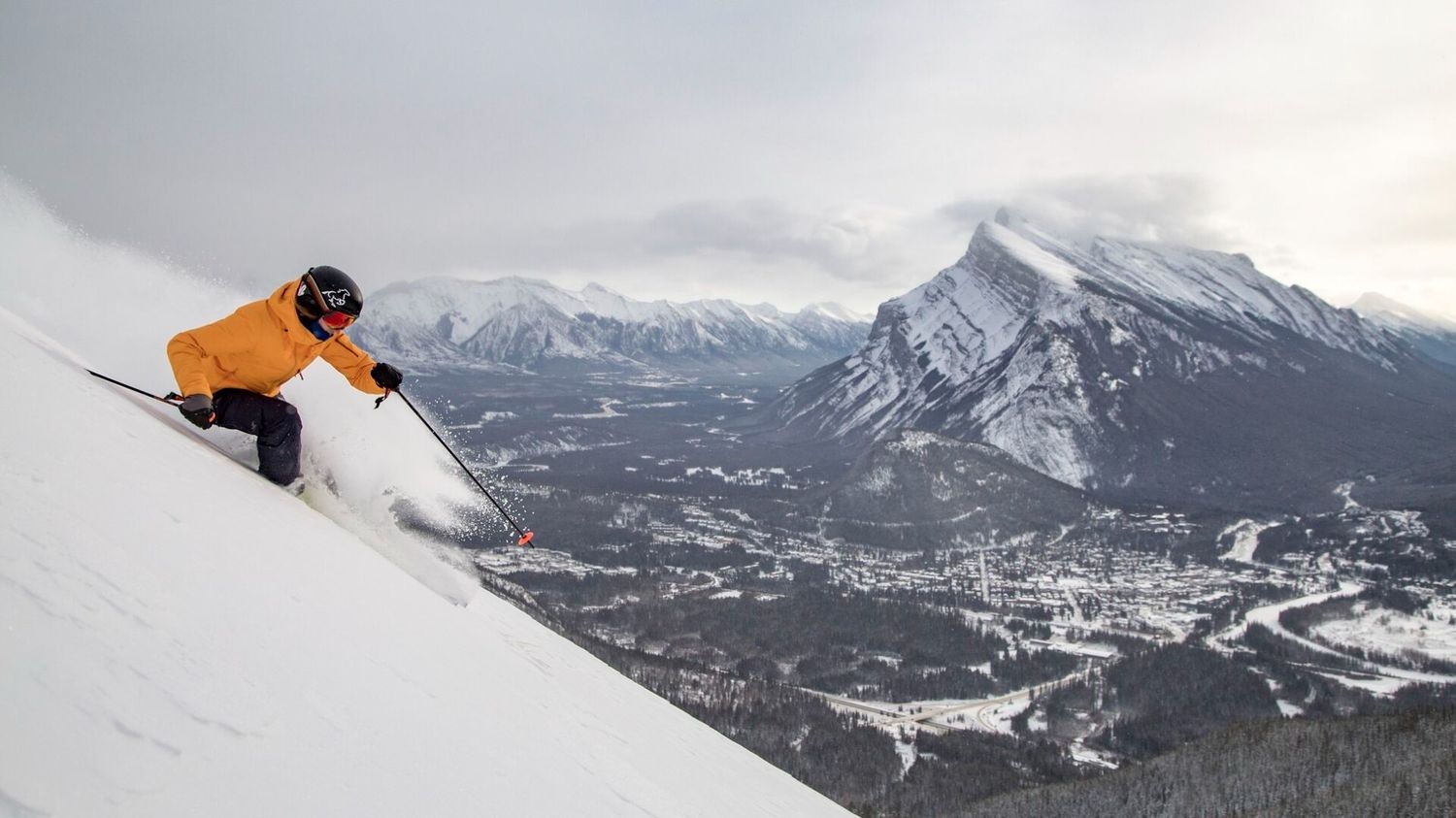 Skier skiing in powder at Banff Ski Resort.