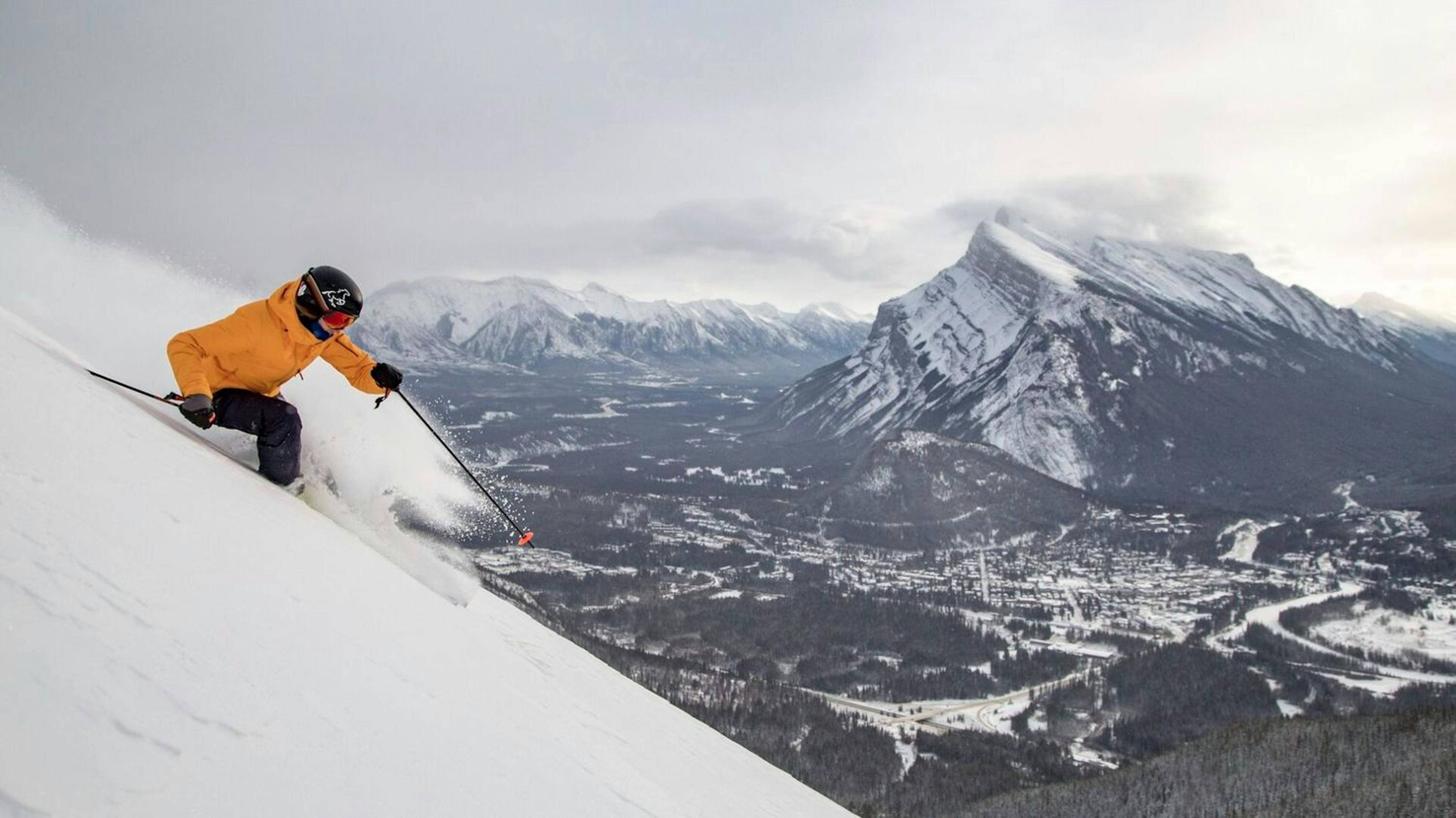 Skier skiing in powder at Banff Ski Resort.