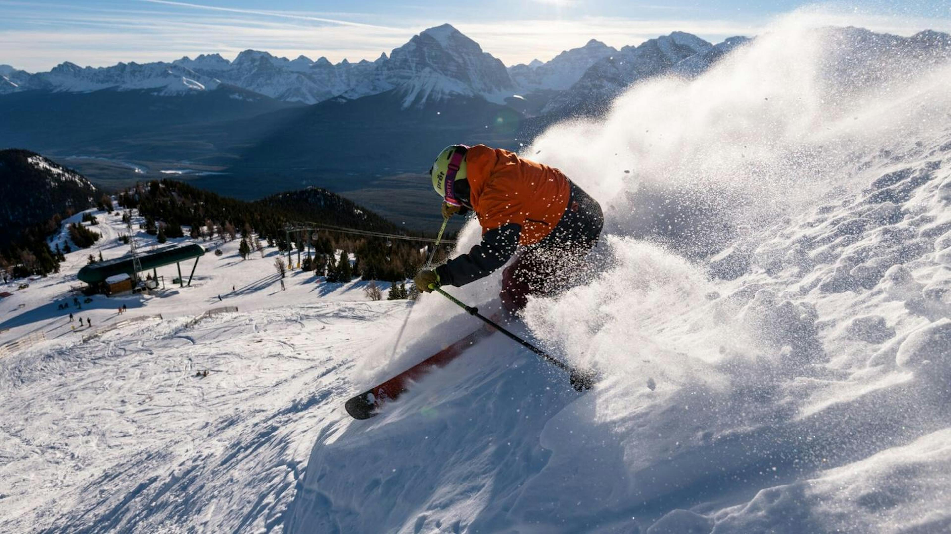 Skier skiing in powder at Banff Ski Resort.