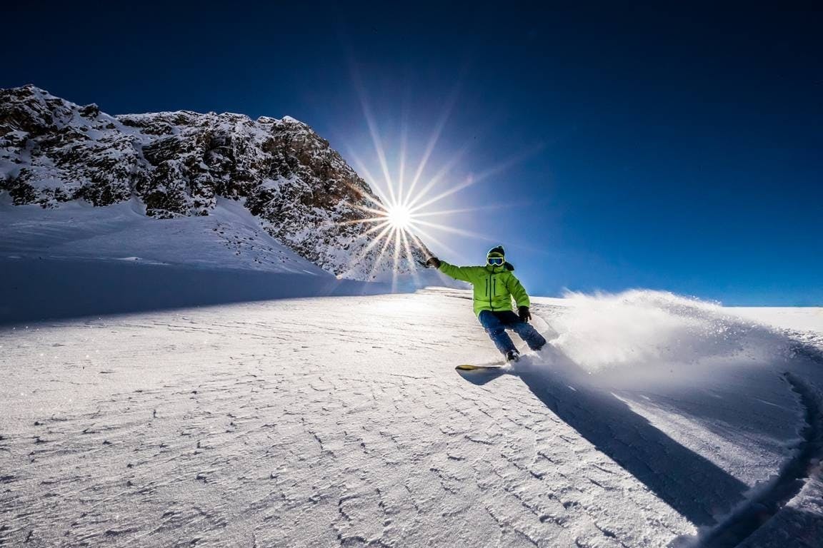 Snowboarder carving at La Thuile.