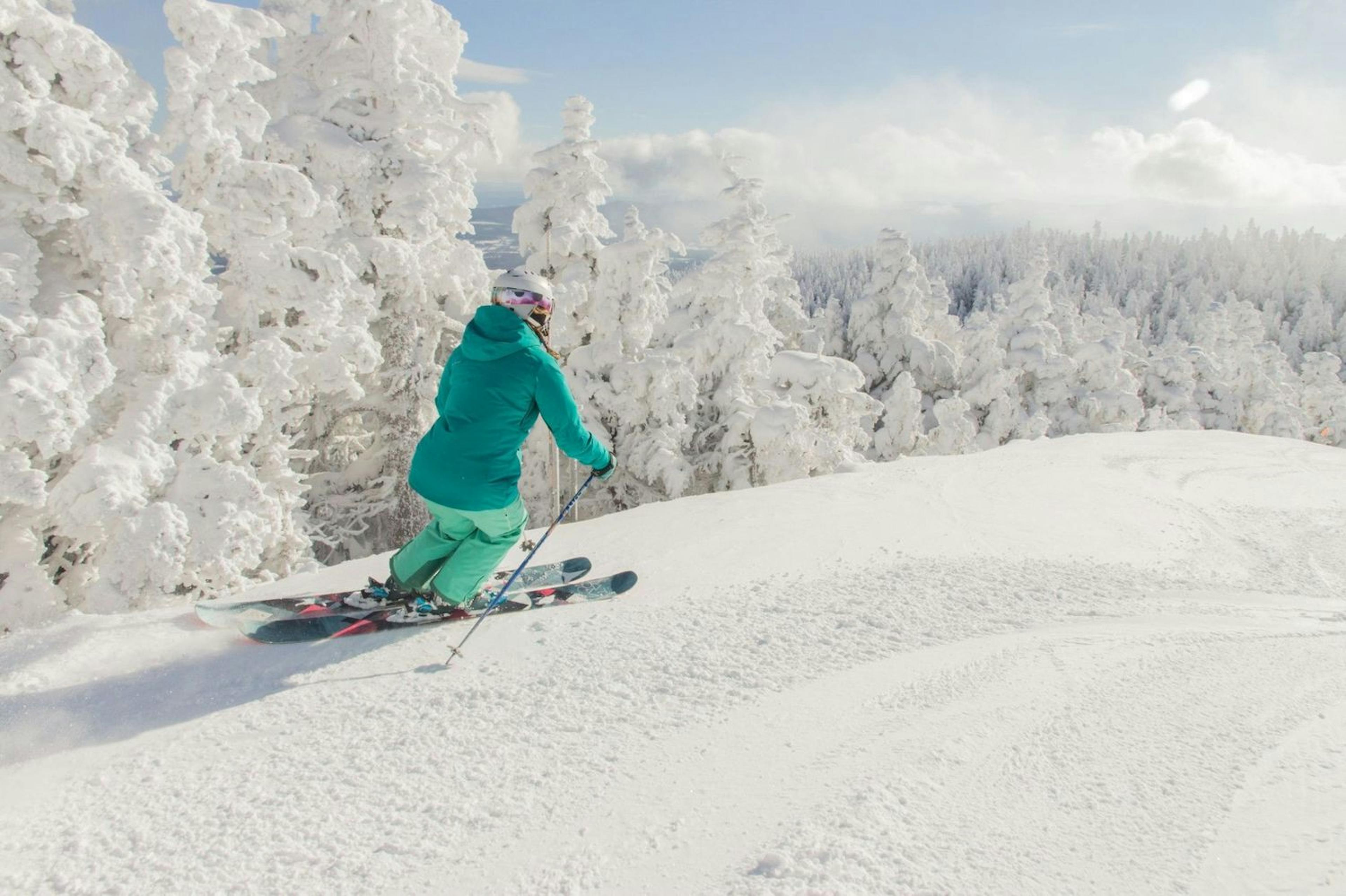 Skier enjoying the snow capped trees at Sugarbush. 