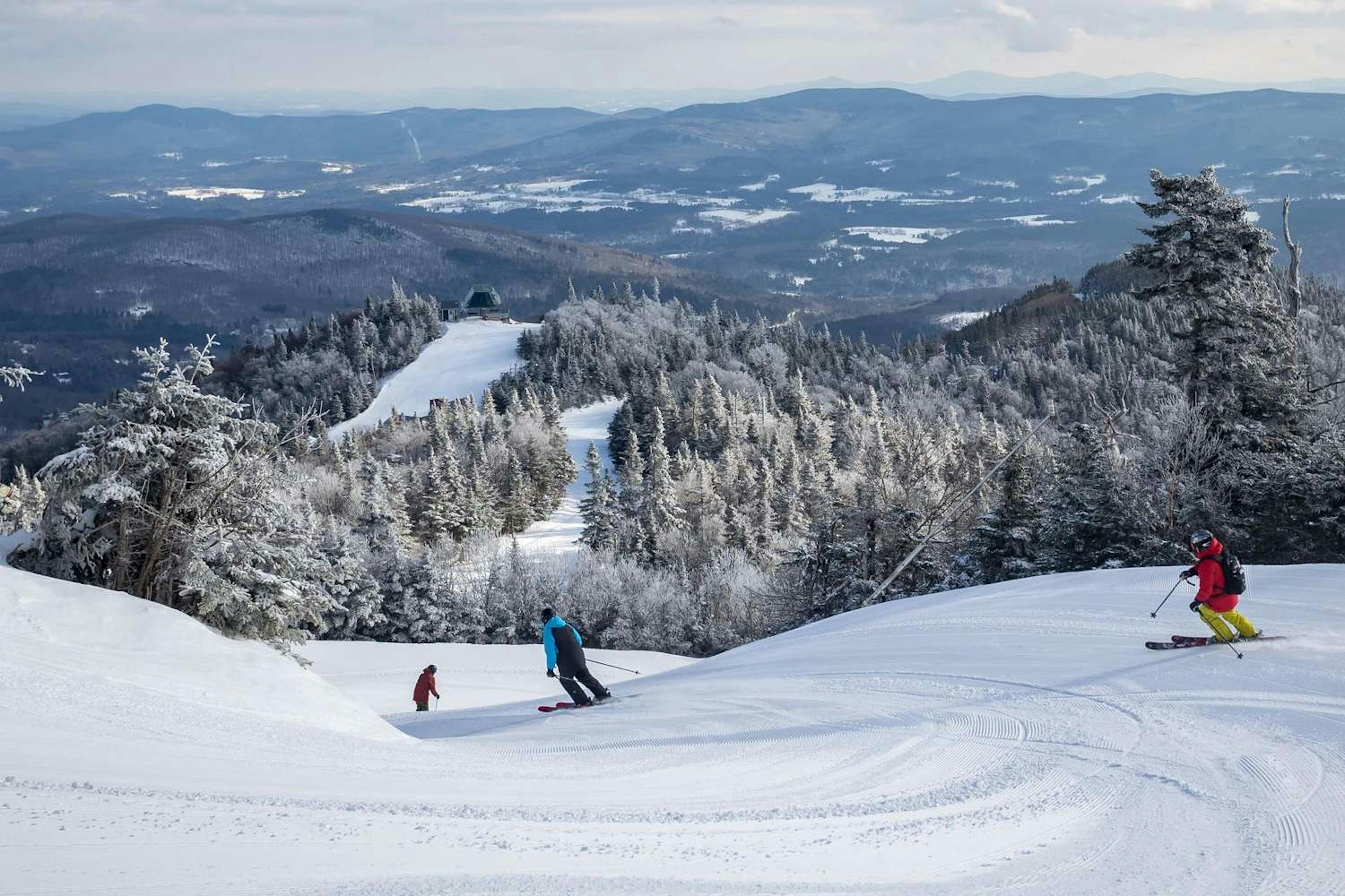  A group of skiers enjoying a sunny day on a snowy slope, carving through fresh powder