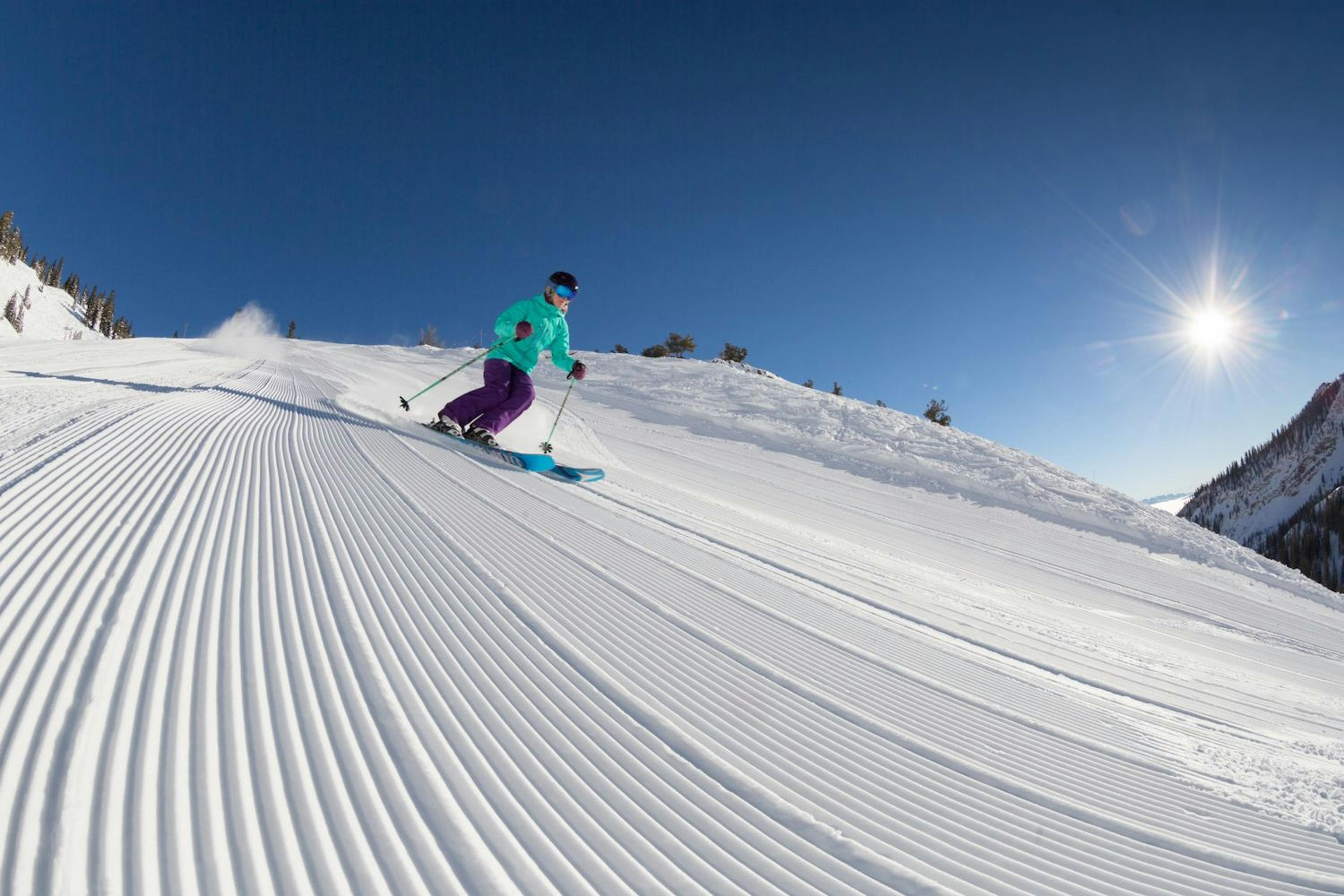 Skier skiing groomed run at Snowbird.