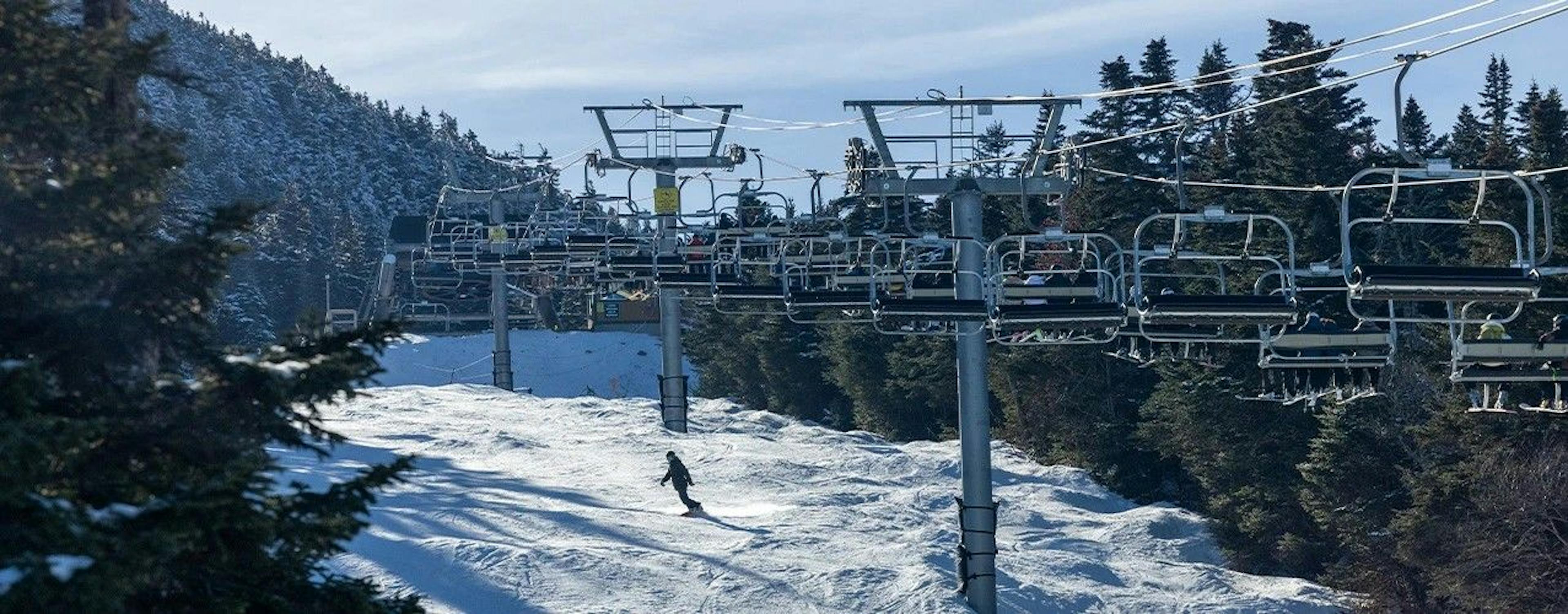 Snowboarder riding moguls at Killington. 