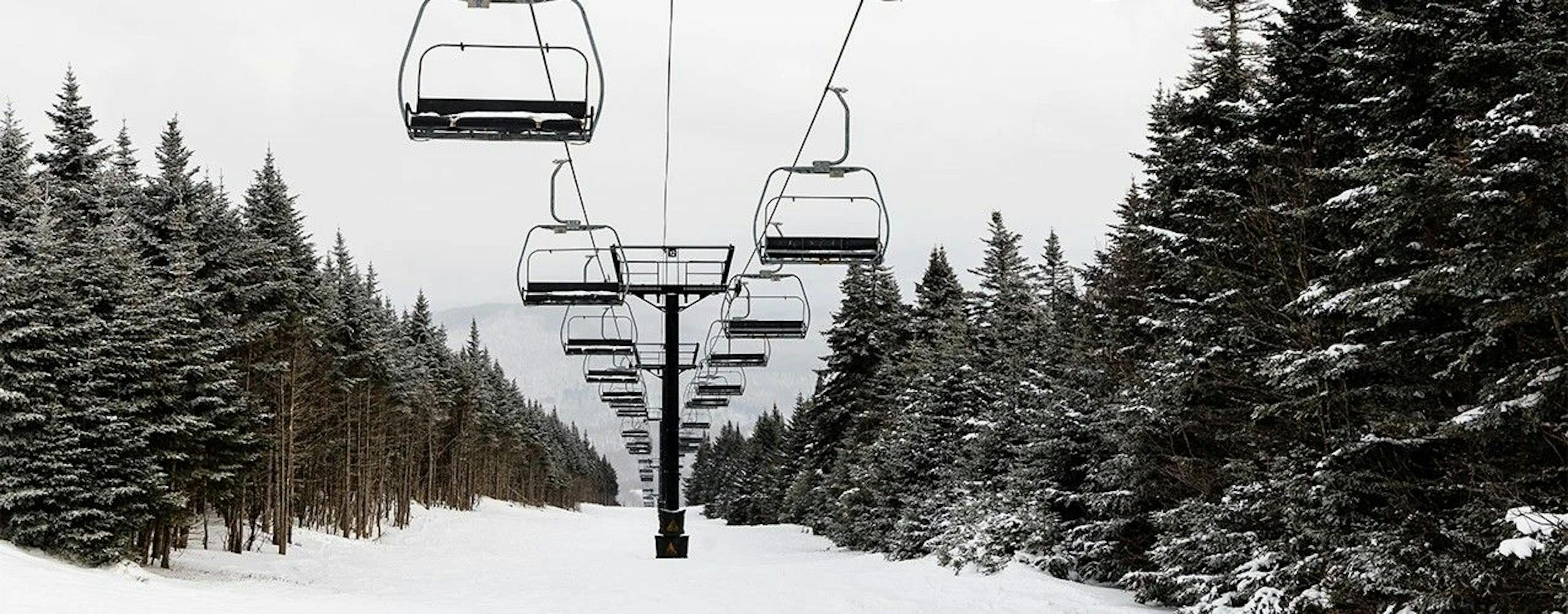 Chairlift in-between trees at Killington. 