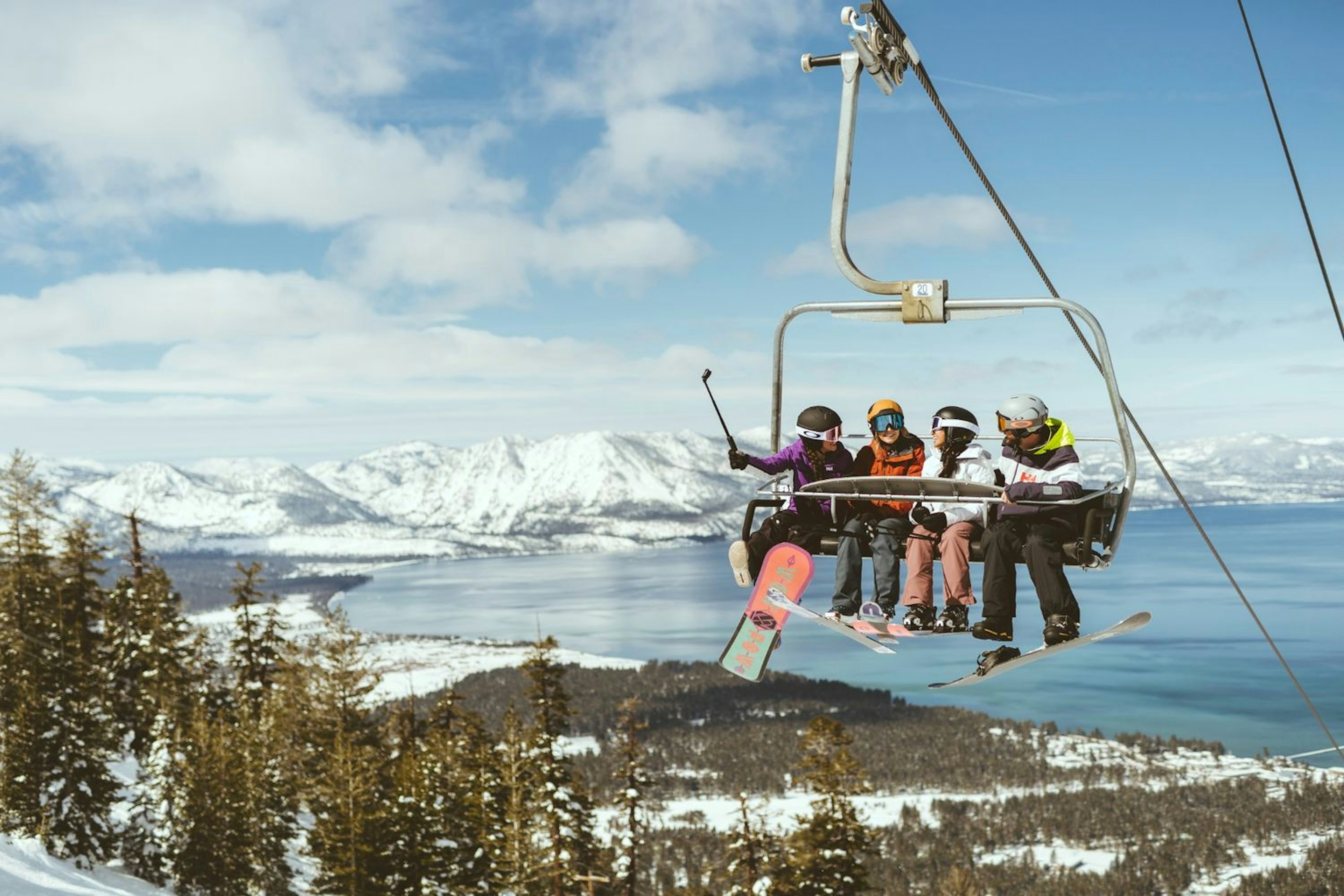 Riders on lift at Heavenly with lake in background.